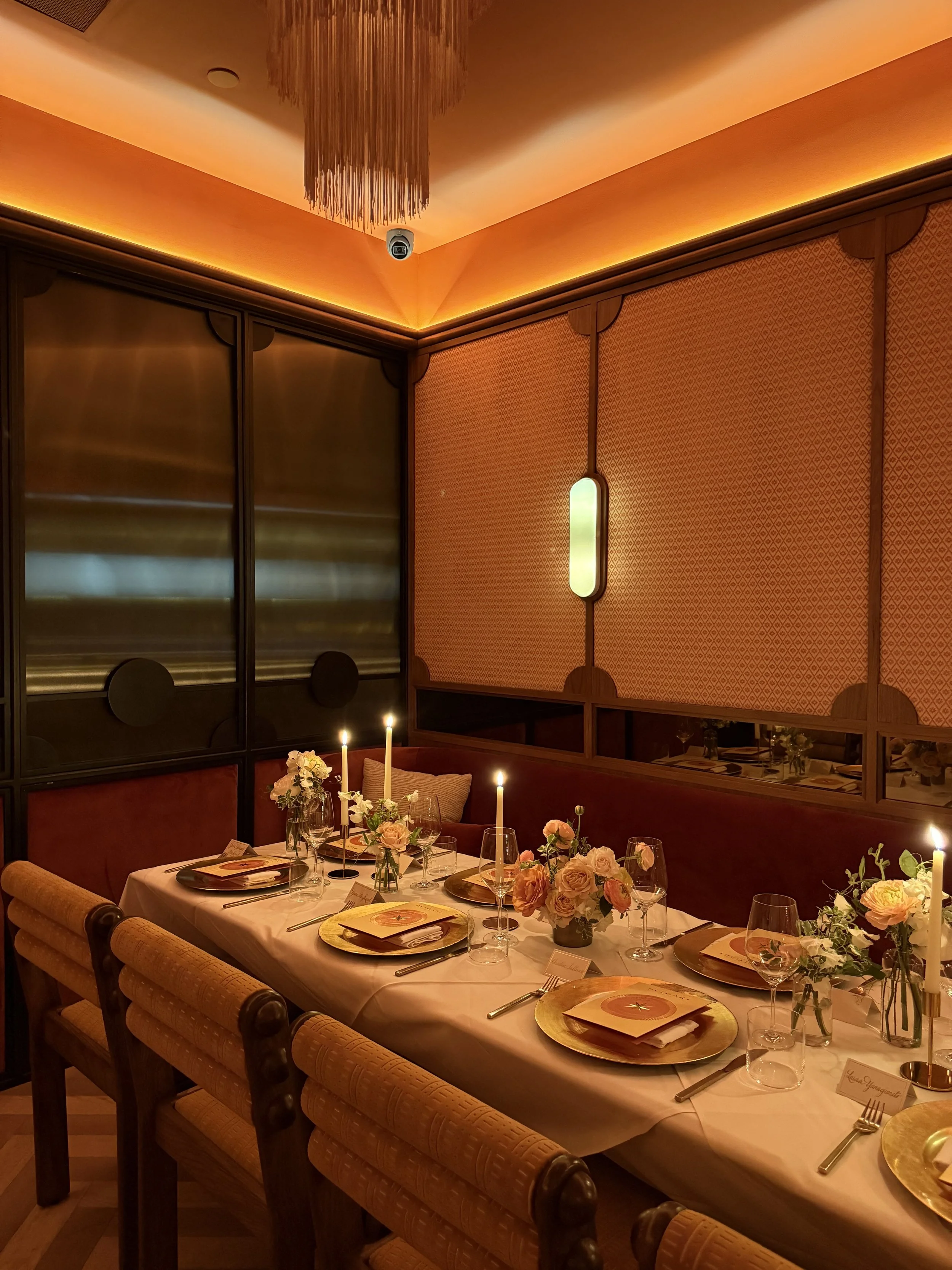 Candlelit Bulgari brand dinner tablescape featuring pastel florals and sculptural details, designed by The Petaler Floral & Events Co., luxury event and wedding designers for Americans in France