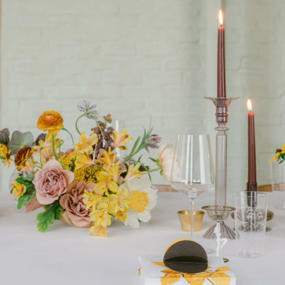 Elegant tablescape with pastel garden-style florals, taper candles, and crystal glassware, designed by The Petaler Floral & Events Co., a luxury wedding planner and floral designer for American couples marrying in France.