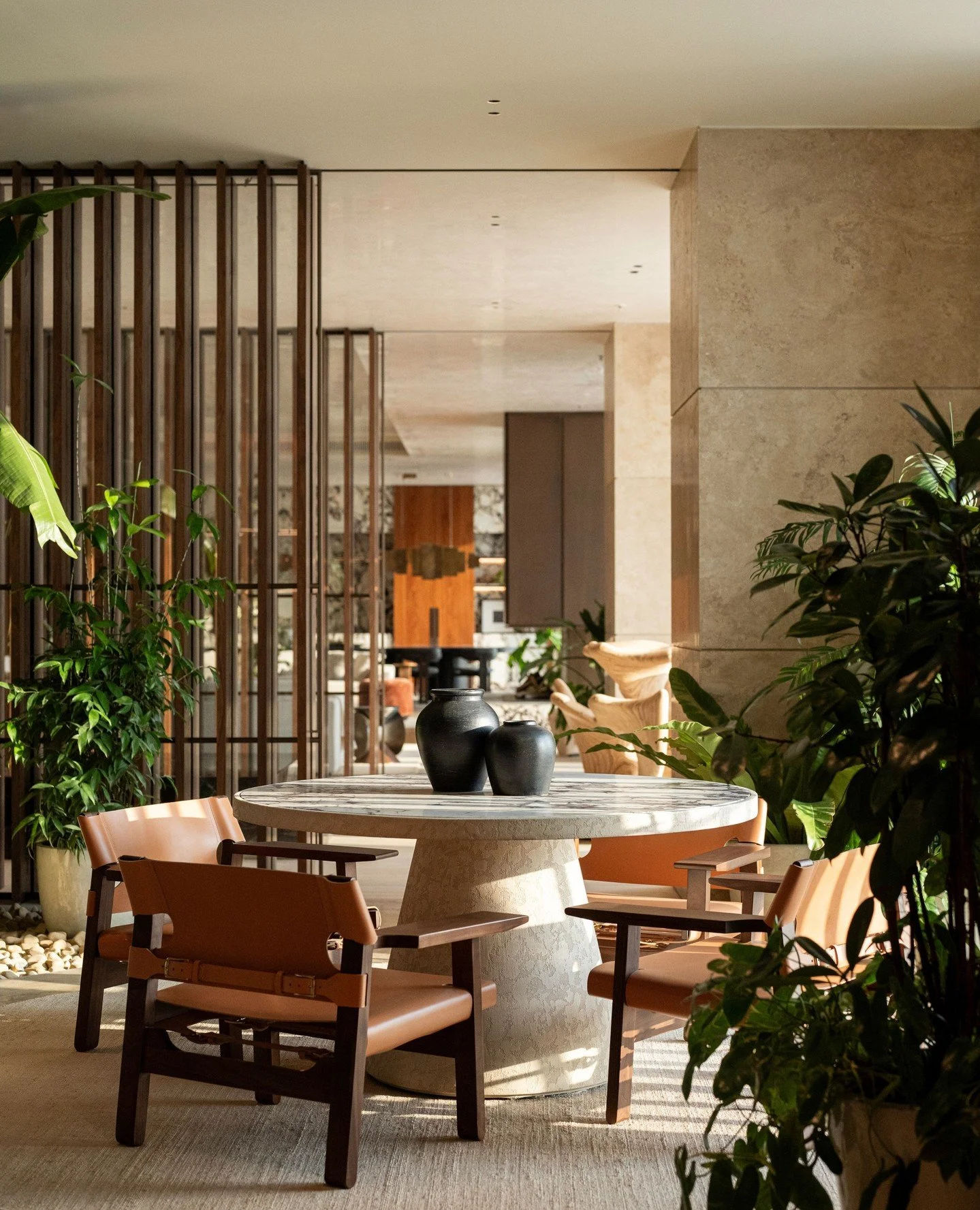 At 360 West, indoor gardens act as natural connectors between formal and intimate spaces. ⁠
⁠
This one bridges the living room and bar. Fully retractable windows blur the line between inside and out with limestone flooring continuing seamlessly into 