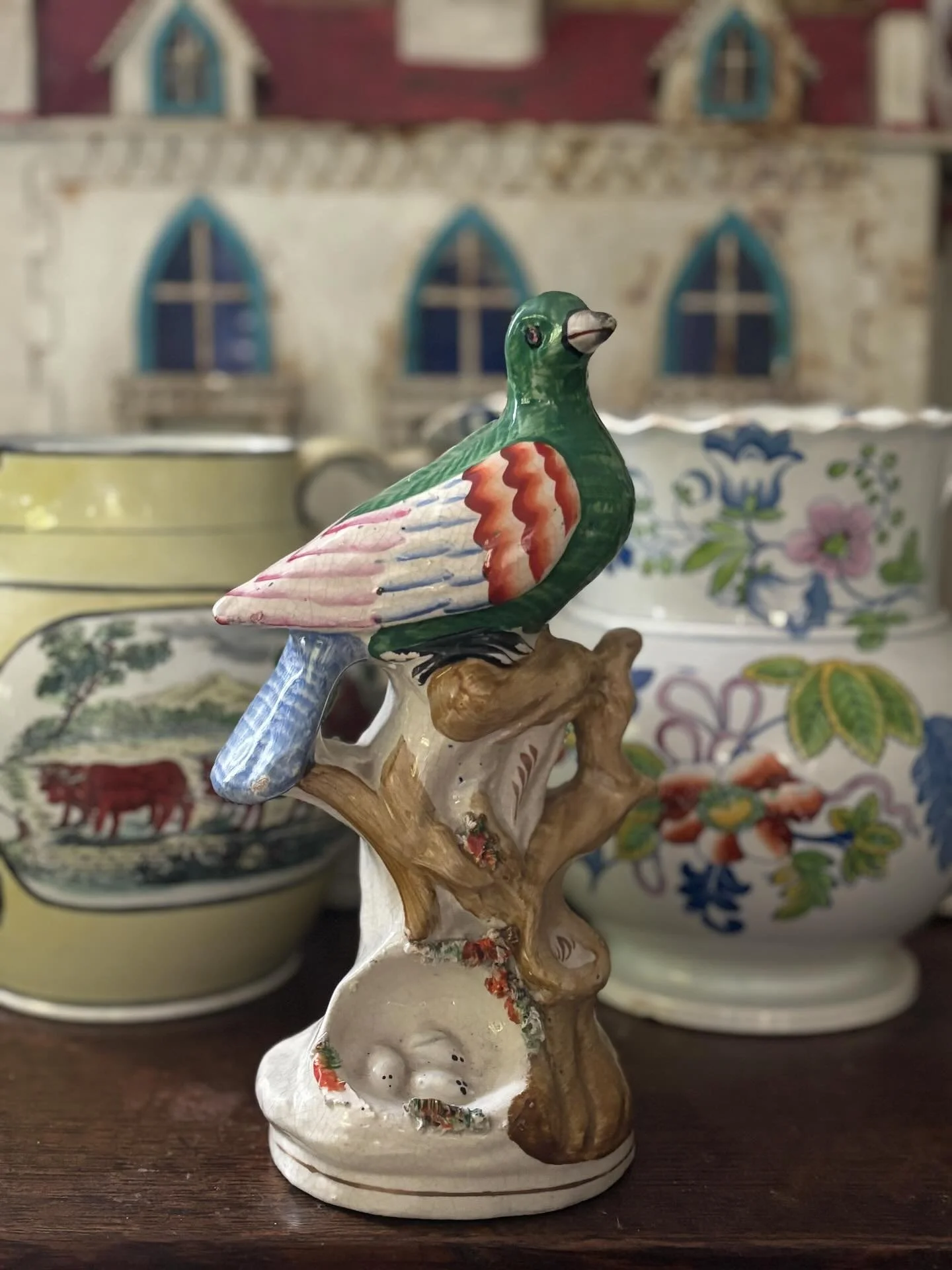 SOLD 🌟 A superb and rare piece of antique Staffordshire pottery, a colourful dove sitting on a tree branch above a little nest of eggs, circa 1860. It is beautifully decorated with feathered brushwork on the chest, back and tail feathers. 

It is in