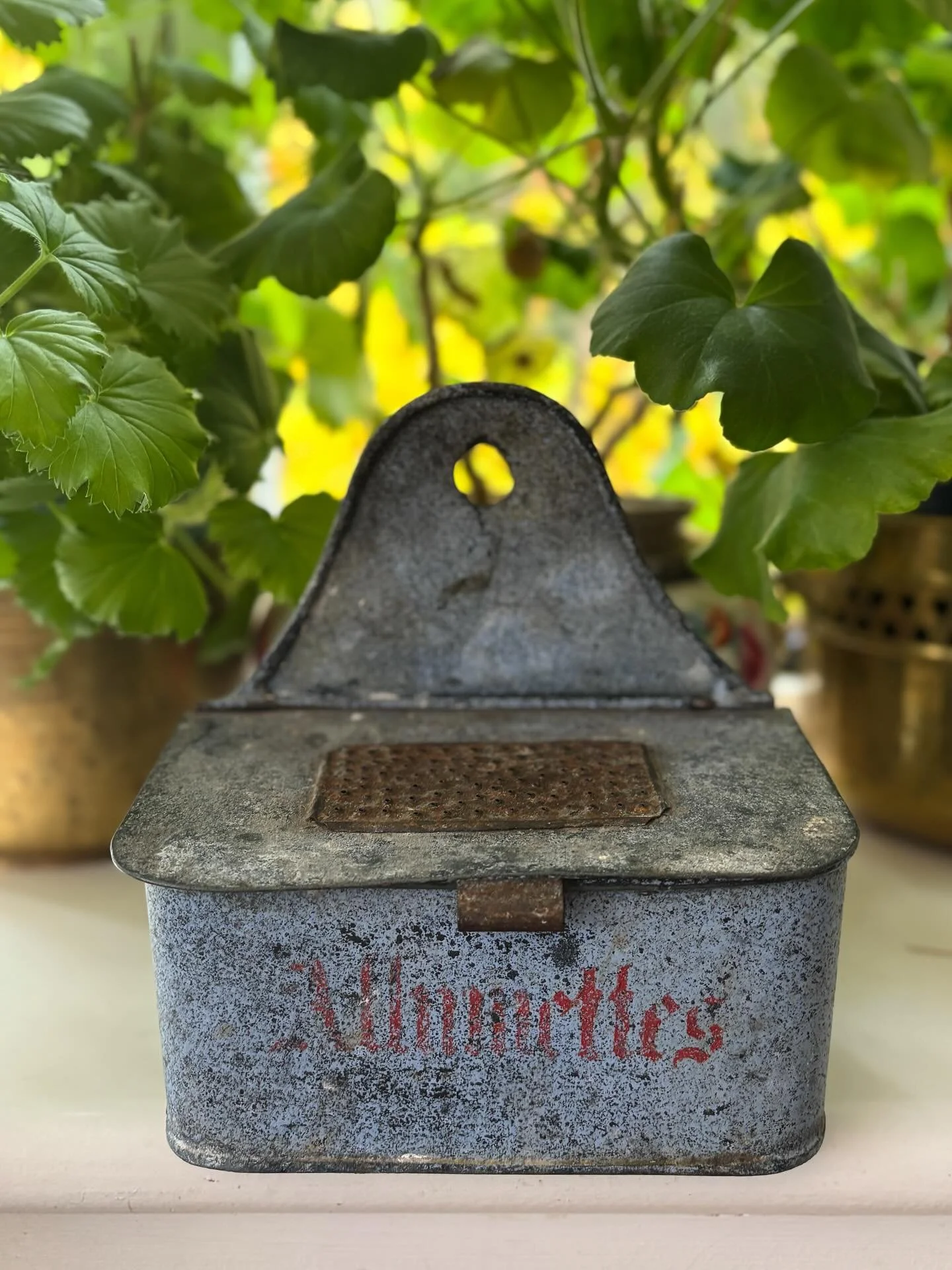 FOR SALE An excellent vintage French allumettes tin. It is a particularly lovely example with red lettering on a speckled (age worn) background and with a match striker on the tin lid. There is an unusual maker&rsquo;s mark on the base. 

14.5cm wide