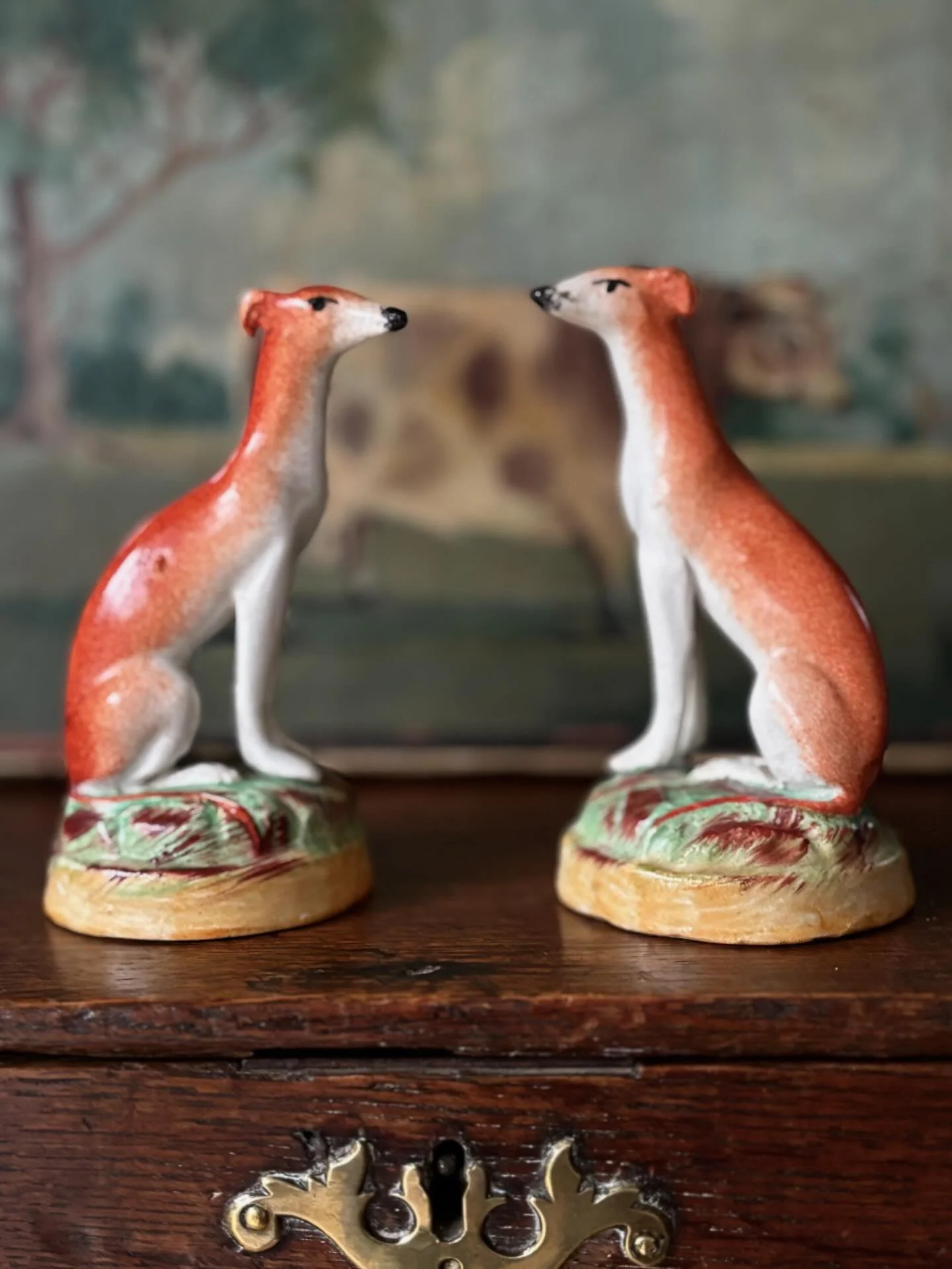 FOR SALE A scarce pair of late 19th century miniature Staffordshire whippets / greyhounds sitting on grassy mounds. 

I have such a soft spot for miniature Staffordshire figures and I have been waiting to find another pair of whippets like this for a