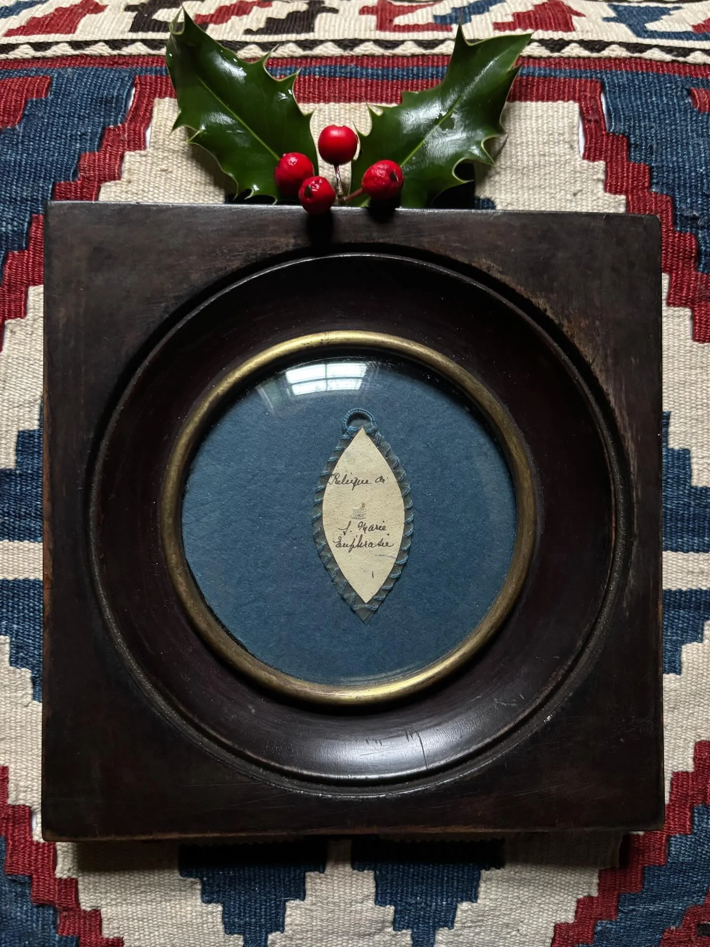 FOR SALE A French religious reliquary of Saint Maria Euphrasia (1796-1868) framed in a dark wood gilt-rimmed frame with convex glass. It contains a tiny fragment of her clothing mounted on a small pendant with stitched edges and a hand written inscri