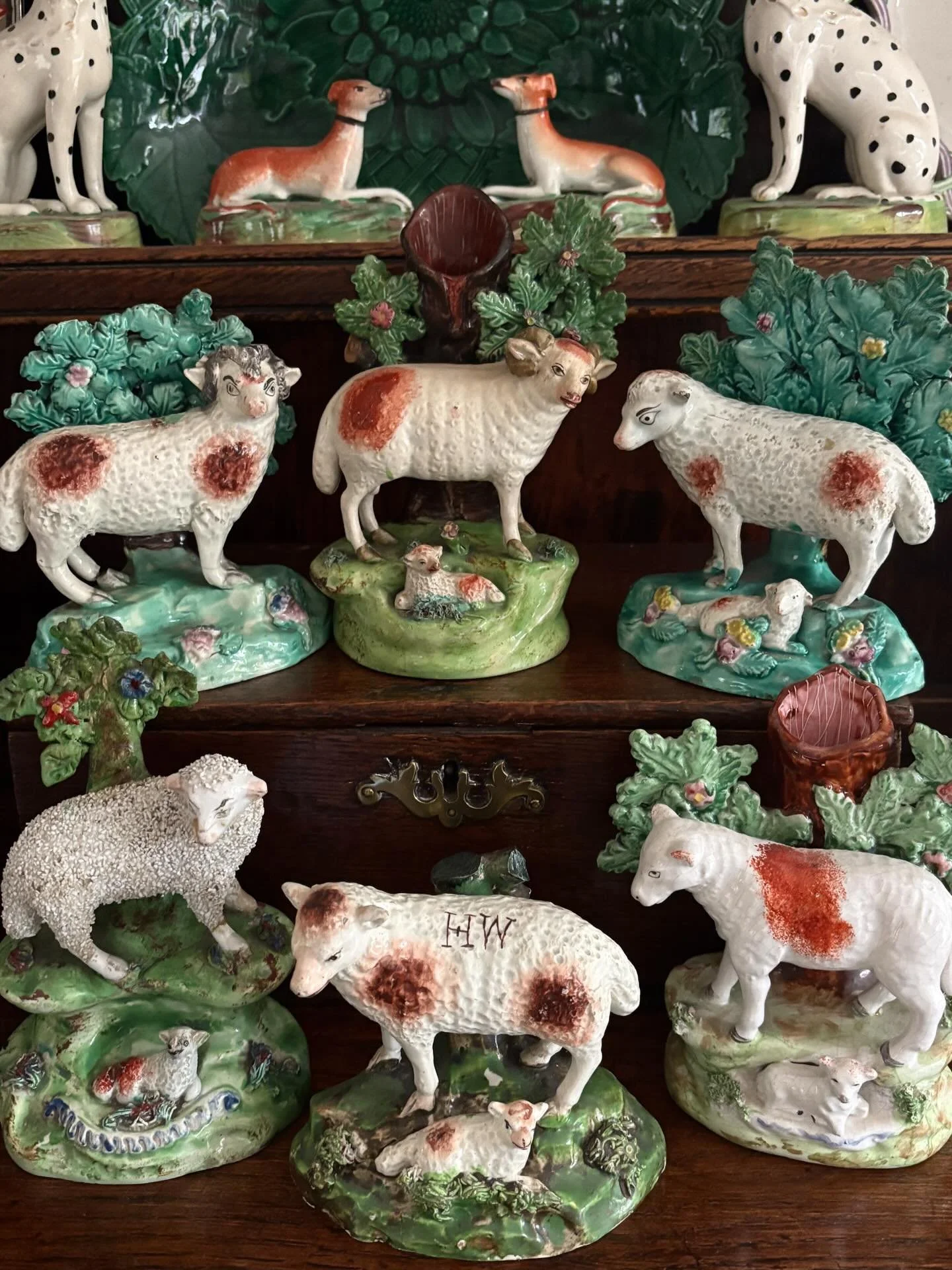 FOR SALE An exceptional pair of Staffordshire pearlware bocage models of a ewe with lamb and a ram, circa 1820. The bocage is superb, dotted with colourful blossom with moulded flowers and leaves decorating the base. 

There is a charming production 