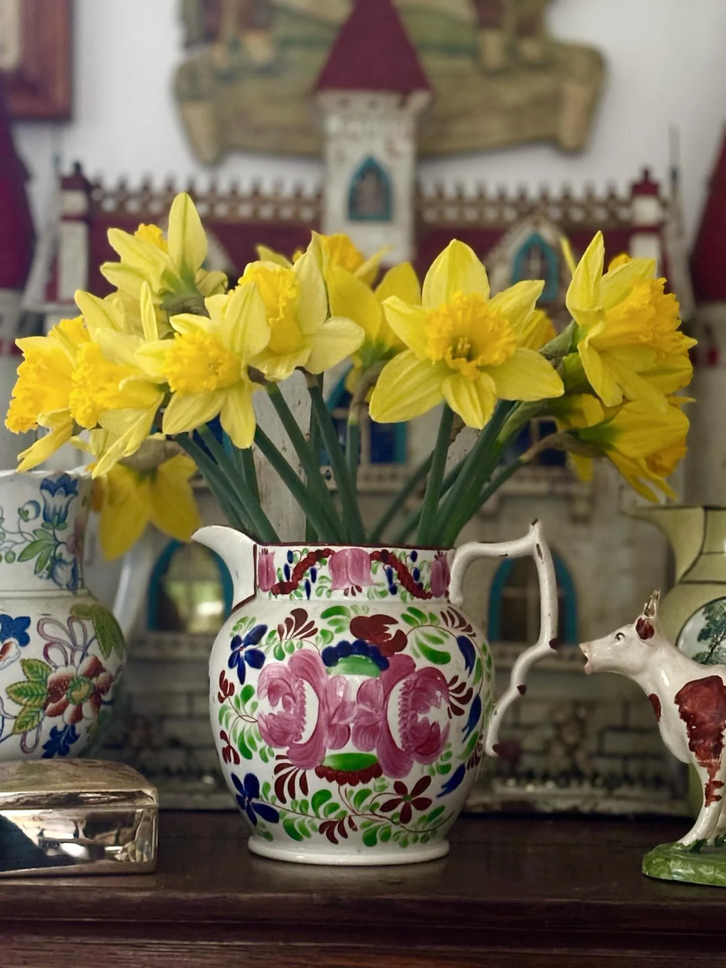 FOR SALE A superlative early 19th century hand painted pearlware jug, circa 1820, likely Welsh. The flamboyant floral decoration and colours are superb. It has a beautifully shaped handle with rust red decoration to match the line around the rim and 