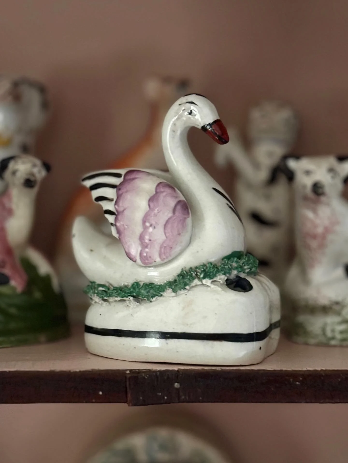 SOLD 🌟 A charming antique Staffordshire pottery swan pen holder, circa 1880. It is a very appealing shape with green moss work decoration around the base and unusual markings on the wings compared to similar figures of this kind.

It is in very good