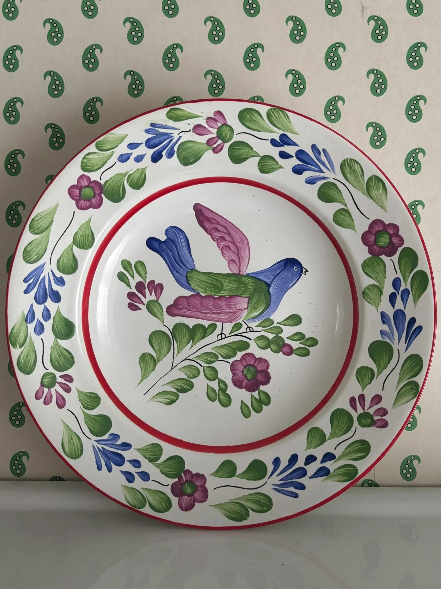 FOR SALE A particularly lovely vintage hand-painted Hungarian plate (or shallow bowl). It is such a pretty piece of pottery with its folk art style floral and bird decoration and bold red bands around the rim and inner edge. 

It is in lovely conditi