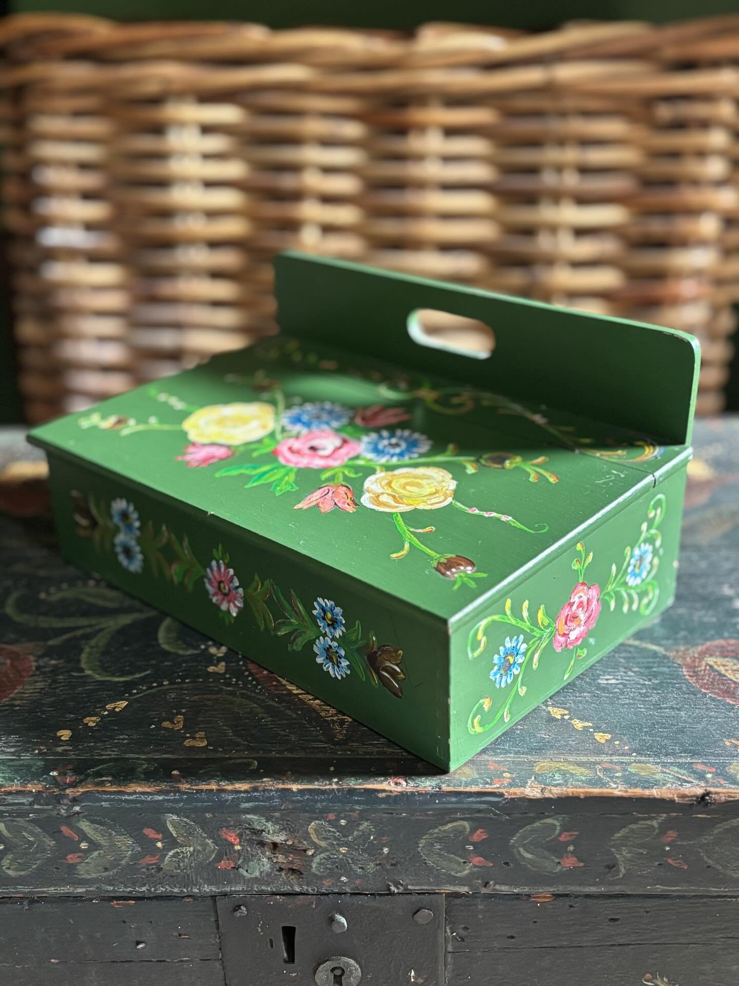 FOR SALE A vintage Dutch wooden tabletop box with hinged lid. It is hand painted with wonderfully vibrant floral decoration on the lid and around the sides in an appealing folk art style. 

It is a decent size and makes such a pretty desktop box, per