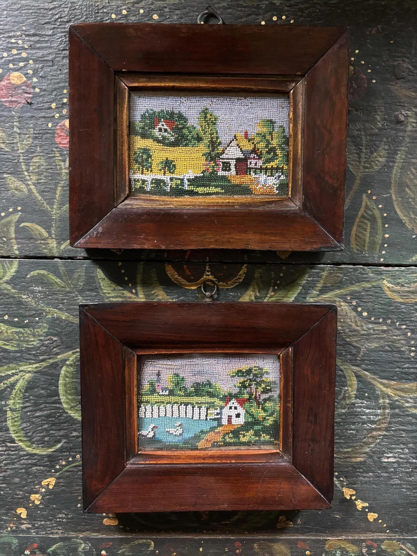 FOR SALE Two superb antique beadwork pictures, mid 19th century. They depict charmingly naive rural scenes, one with a cottage beside a duck pond and a church in the background, the other featuring a pretty cottage set within a verdant rural landscap