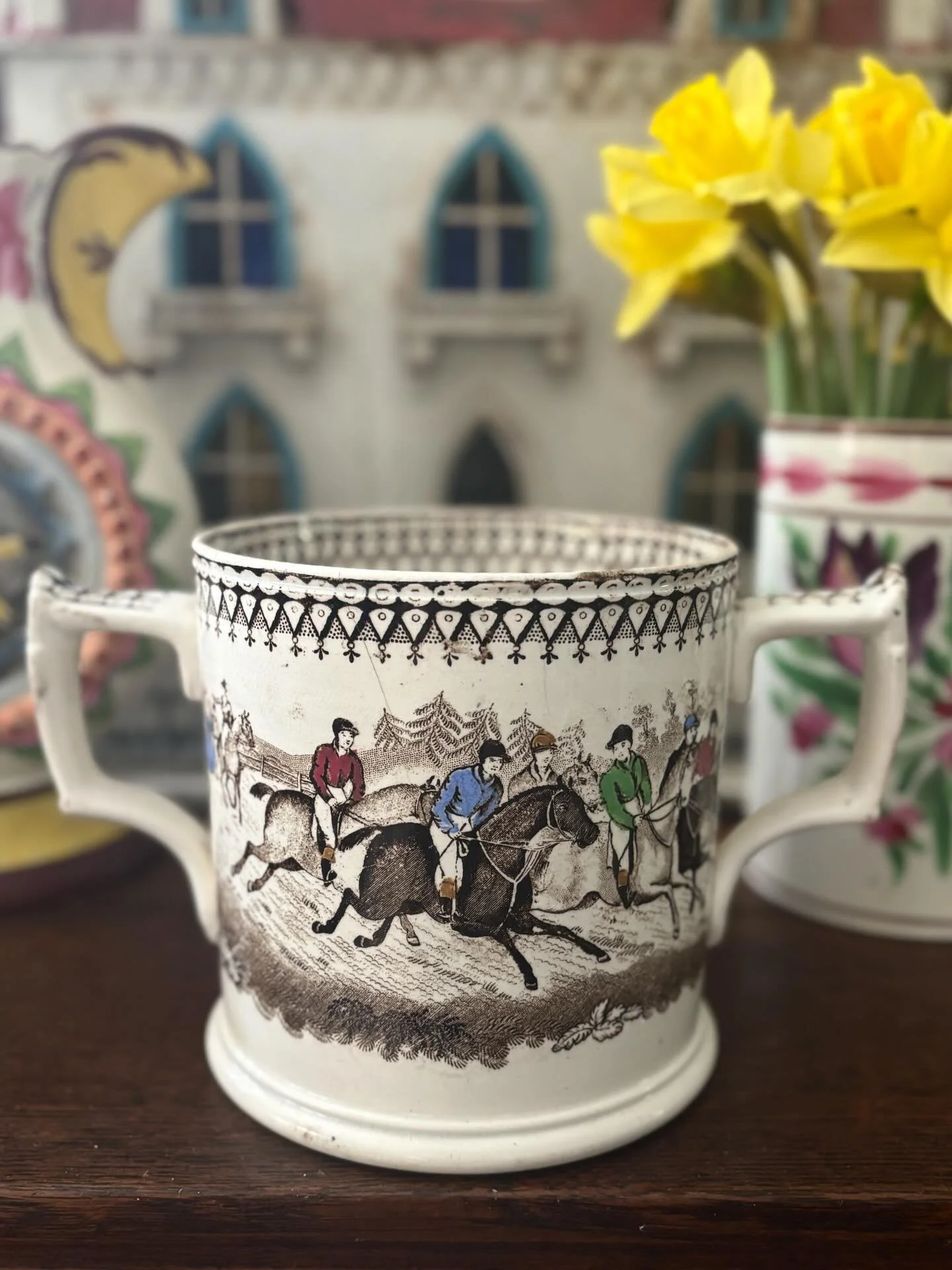 FOR SALE A magnificent antique two-handled &lsquo;Steeple Chase&rsquo; tankard by J &amp; R Godwin, circa 1845. It is transfer printed in dark brown with the jockeys&rsquo; silks, caps and boots hand coloured in blue, green, plum and yellow ochre. An