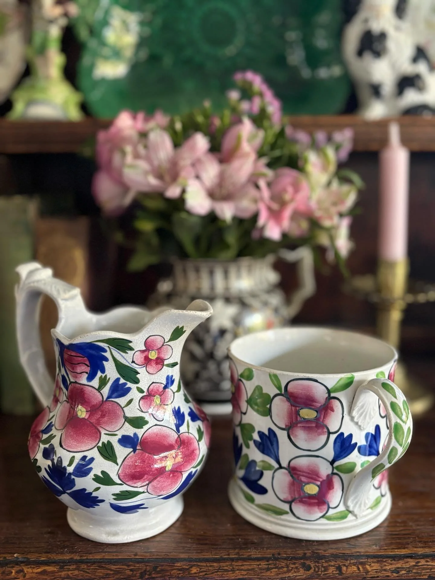 FOR SALE Two vibrant and striking pieces of mid 19th century pottery, each decorated in wonderfully bold floral patterns, hand coloured in plum red, cobalt blue and green. 

1.) An antique earthenware jug with ornately shaped handle. What a charming 