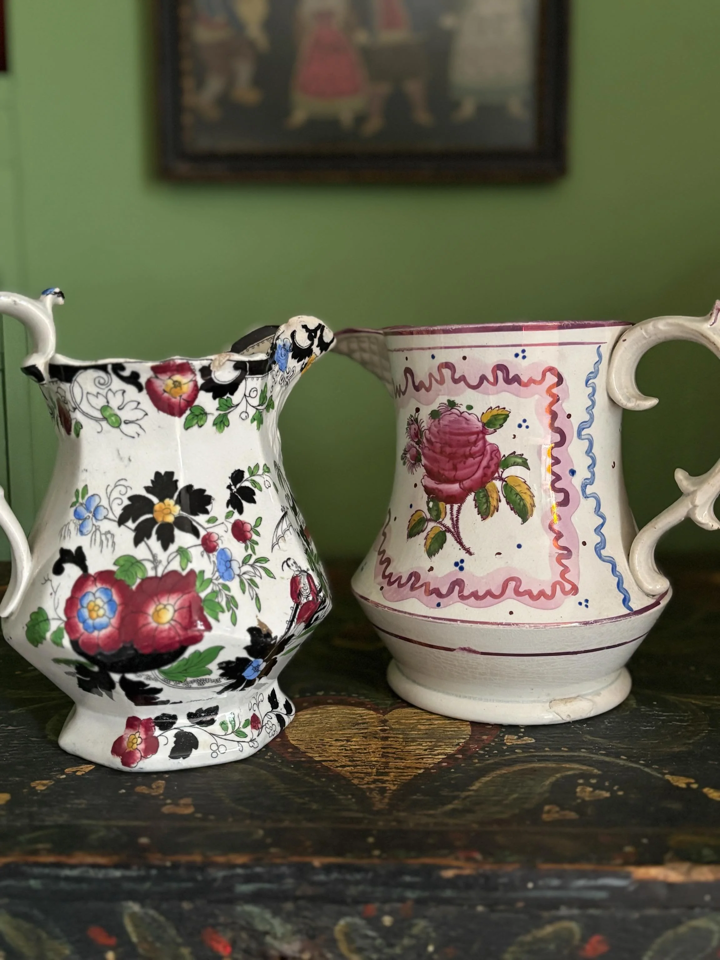 FOR SALE Two fabulous 19th century floral jugs with ornately shaped handles. 

1.) A very pretty antique transferware jug with a vibrant hand coloured pattern of flowers and chinoiserie scenes.  Moulding to the spout. 

In good antique condition. The