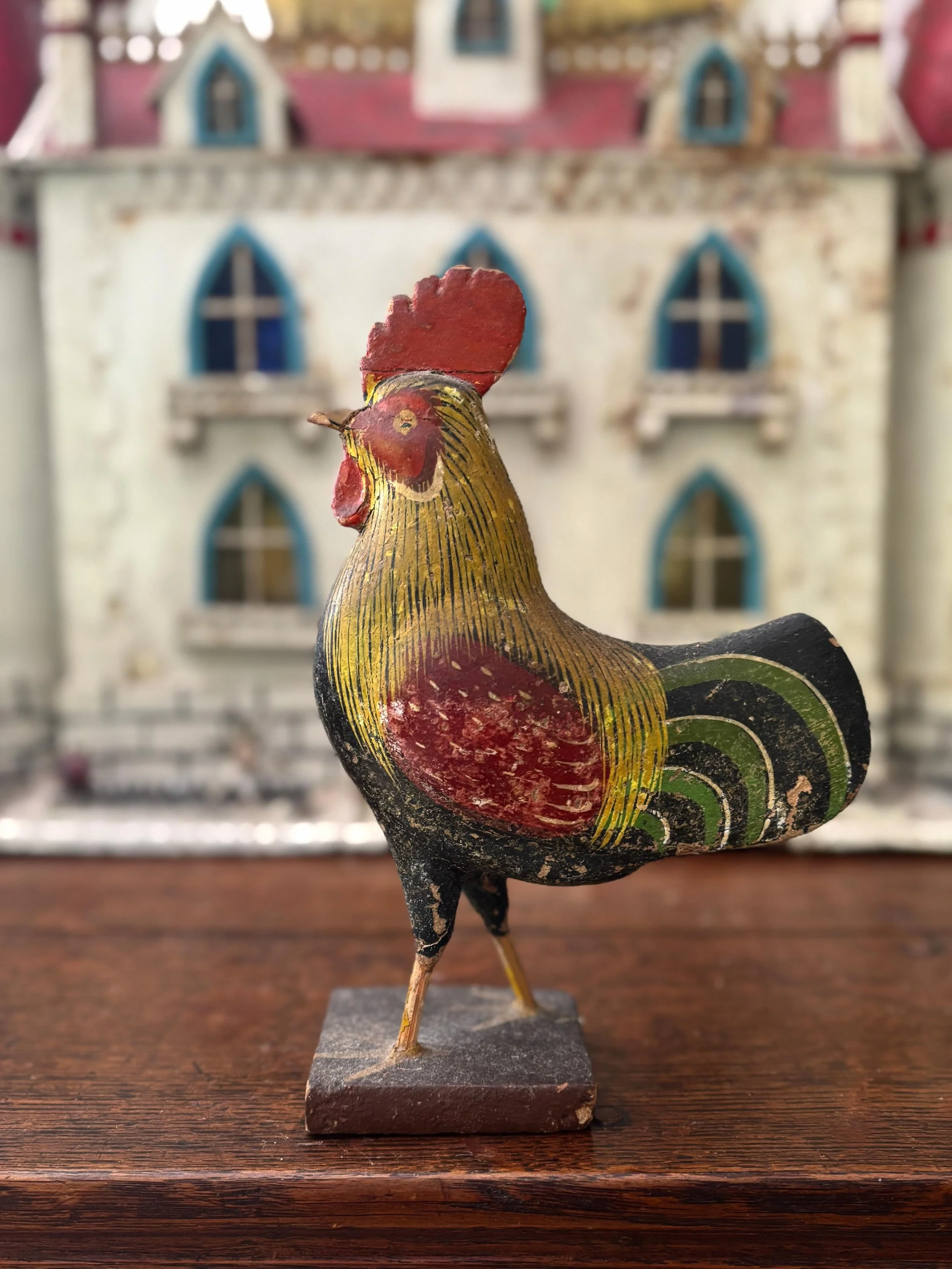 FOR SALE A vintage folk art hand painted wooden cockerel on a wooden plinth base. He is a splendid creature with a tall red comb and superb markings. His feet have been painted onto the base, a lovely detail. 

In good condition. Some chips and scrat