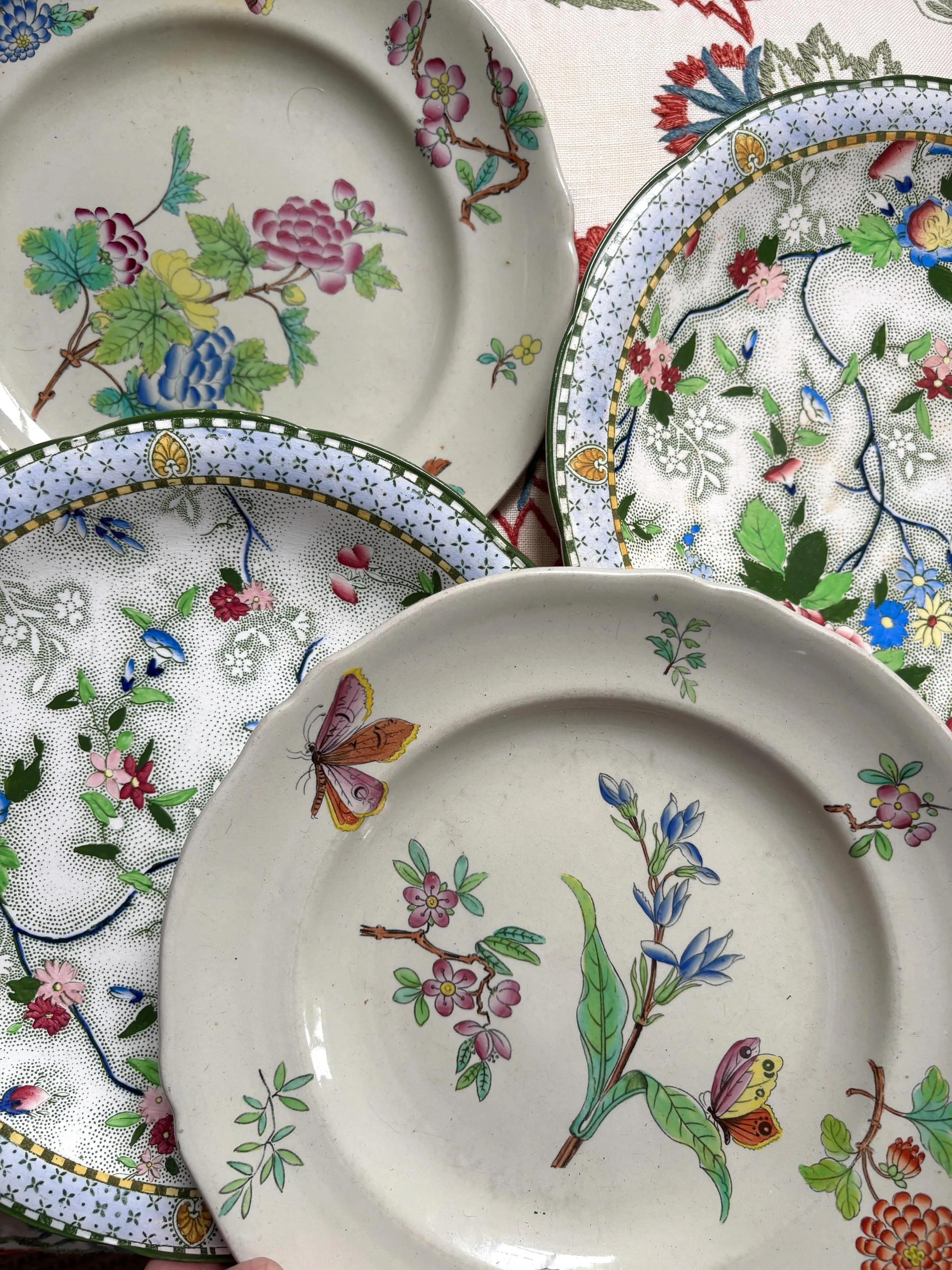 FOR SALE 

1.) A pair of beautiful grey-toned plates decorated with flowers and butterflies. The decoration has the look of antique Chinese celadon, a gorgeous combination of butterflies, peonies, Chinese roses and other flowers. They are in good con