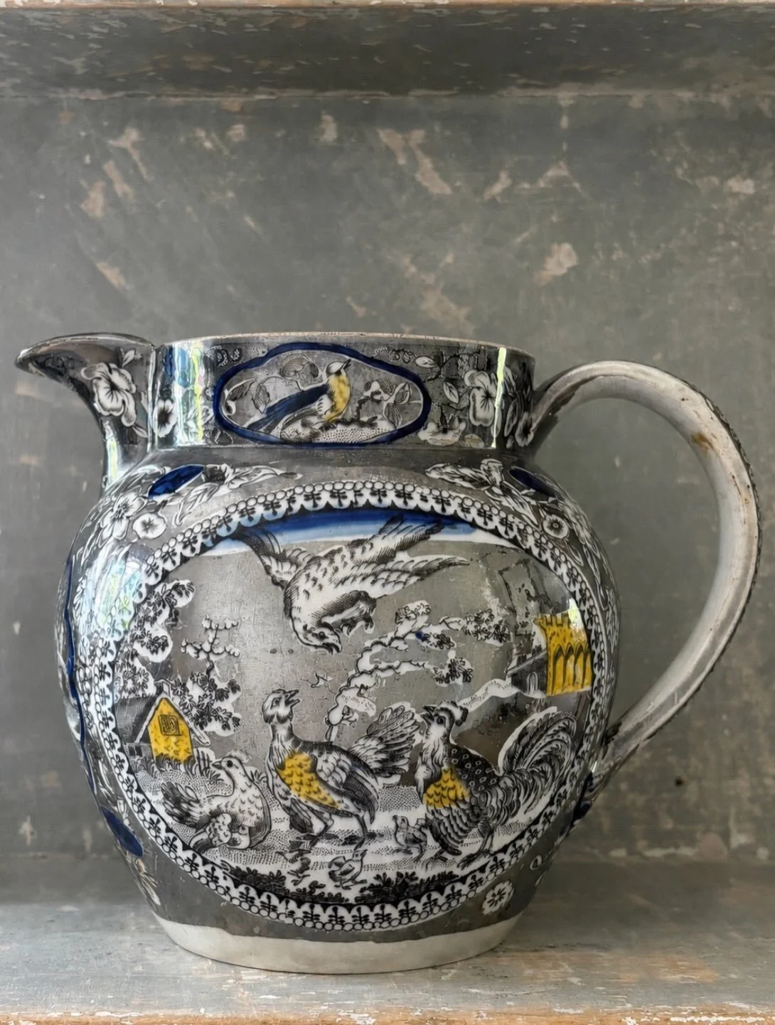 FOR SALE An exceptional early 19th century English silver lustre jug with transfer printed decoration of country scenes, circa 1815. Hand colouring in yellow ochre and cobalt blue.

The details are absolutely superb. The decoration features classic r