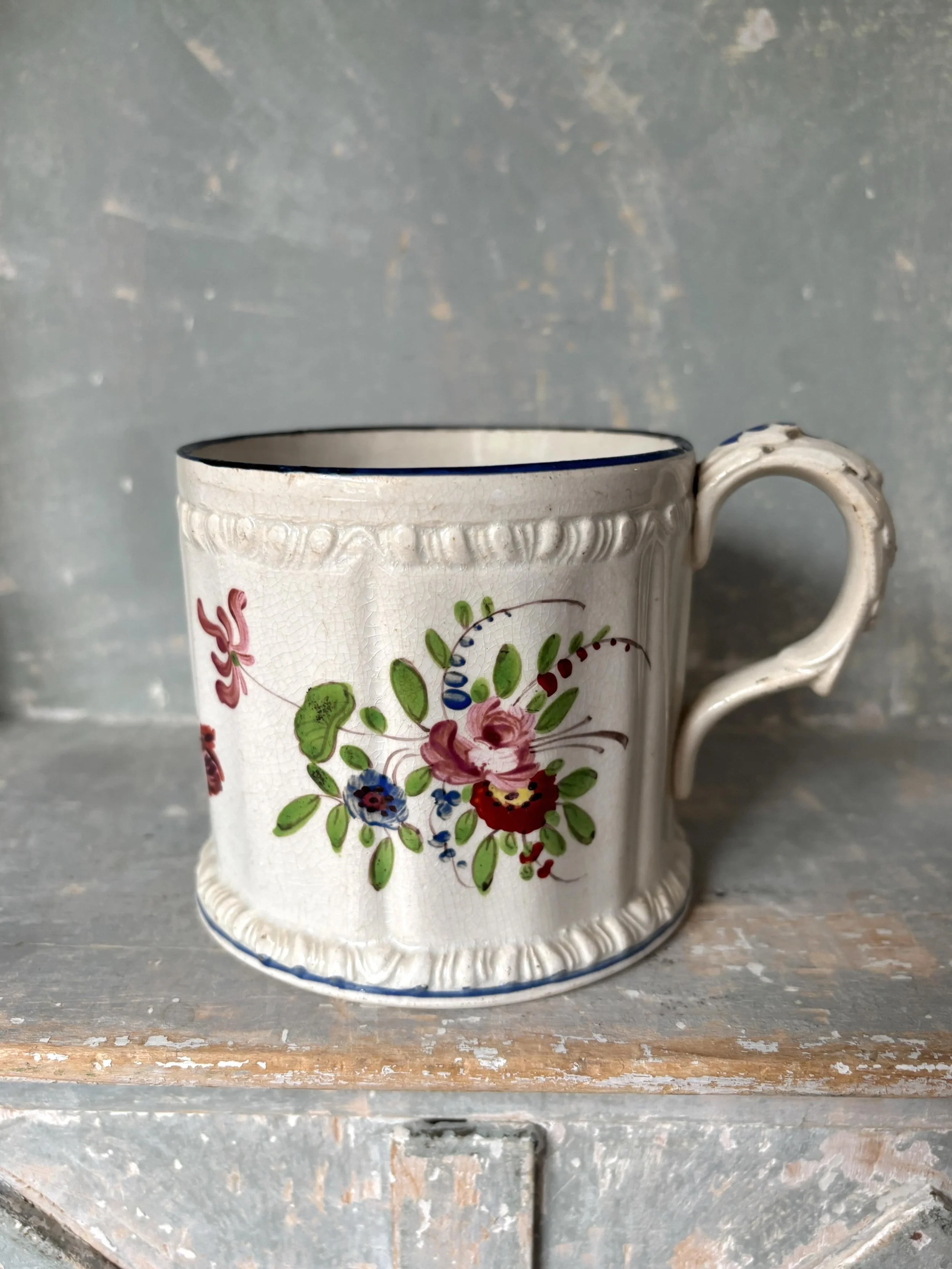 FOR SALE The most perfect Georgian moulded and hand decorated mug, circa 1815. 

The hand painted floral sprigs are beautifully rendered and feature honeysuckle, roses and a glorious tulip amongst other flowers. There are moulded decorative bands bel