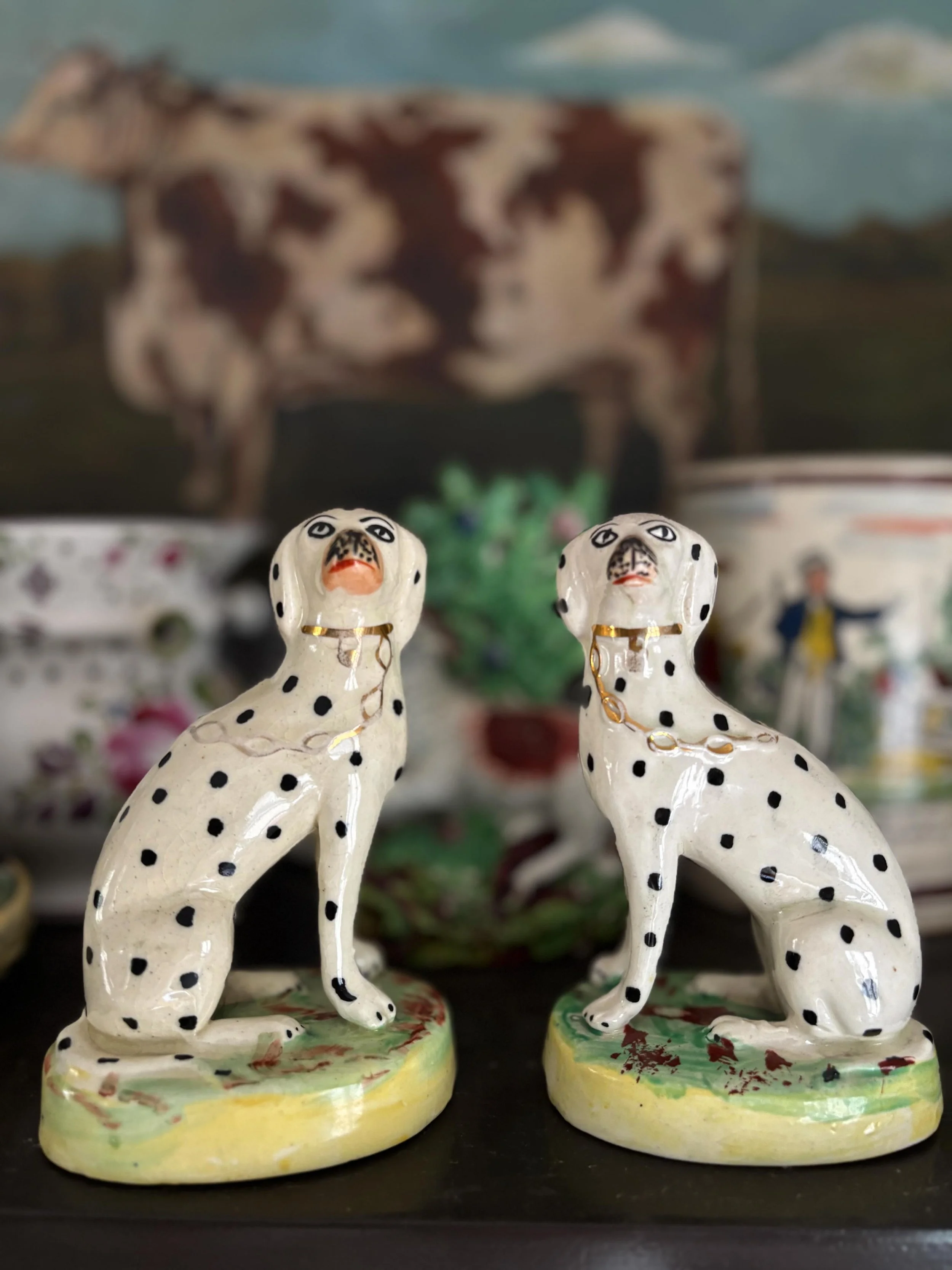 FOR SALE A superb pair of antique Staffordshire pottery Dalmatians on green oval bases with gilt detailing, circa 1880. 

As one would expect, they have fabulously snooty expressions and make the most wonderful pair in all their entitlement! 

They a