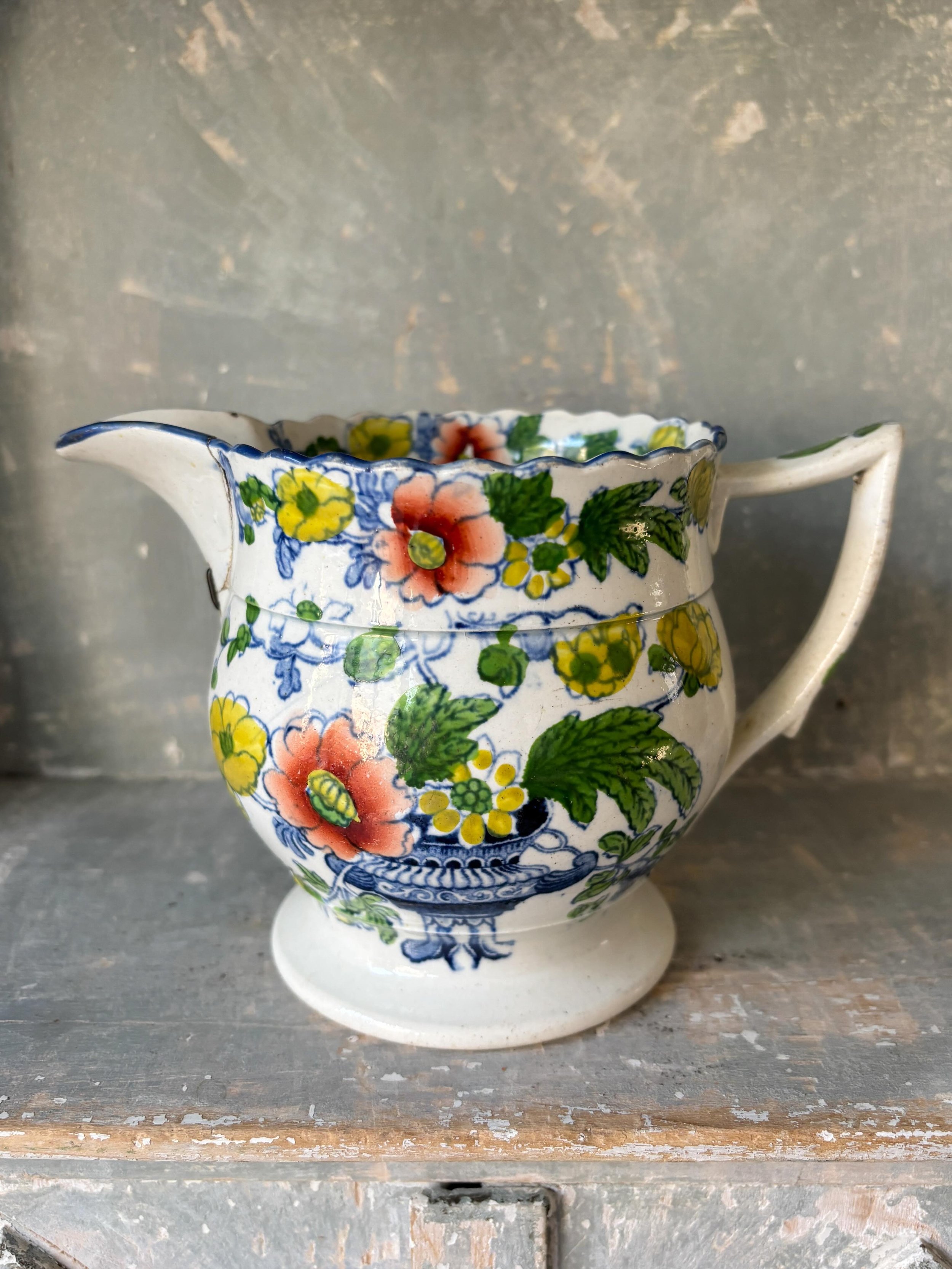 FOR SALE A rare Cambrian pottery pearlware jug, circa 1820. It is transfer printed in blue and hand painted with polychrome flowers and foliage in green, yellow and orange. It has a beautiful scalloped rim. 

It is a rare gem. 

As detailed on the la