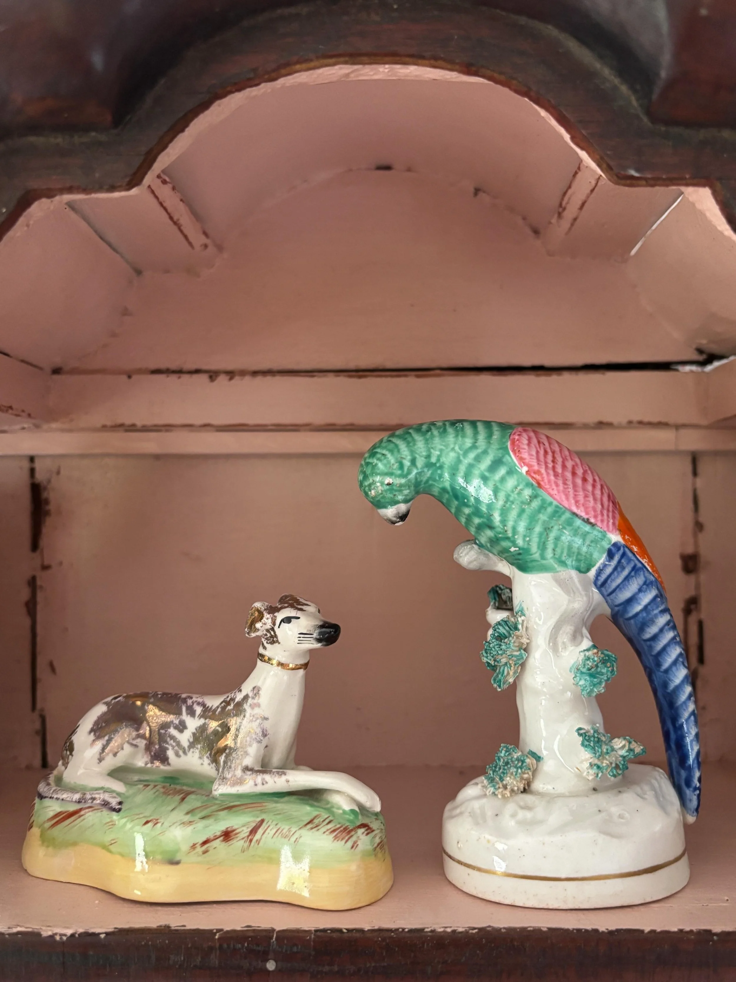 FOR SALE Two charming Staffordshire pottery figures

1.) An antique Staffordshire pottery figure of a small polychrome parrot perched on a tree stump, circa 1860. There is a gilt band around the base and the tree stump is adorned with mosswork. 

It 