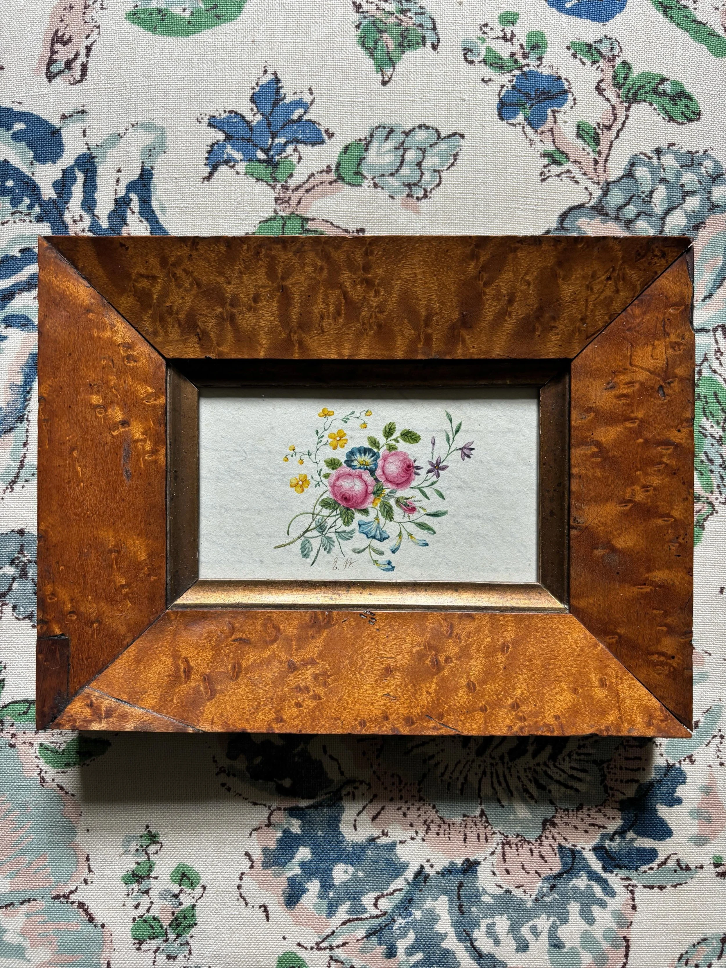 FOR SALE A 19th century floral watercolour painting in a beautiful antique birdseye maple frame, circa 1840. It is a wonderfully refined painting, the sprig of flowers rendered in exquisite detail. It was likely painted on the reverse of a letter as 