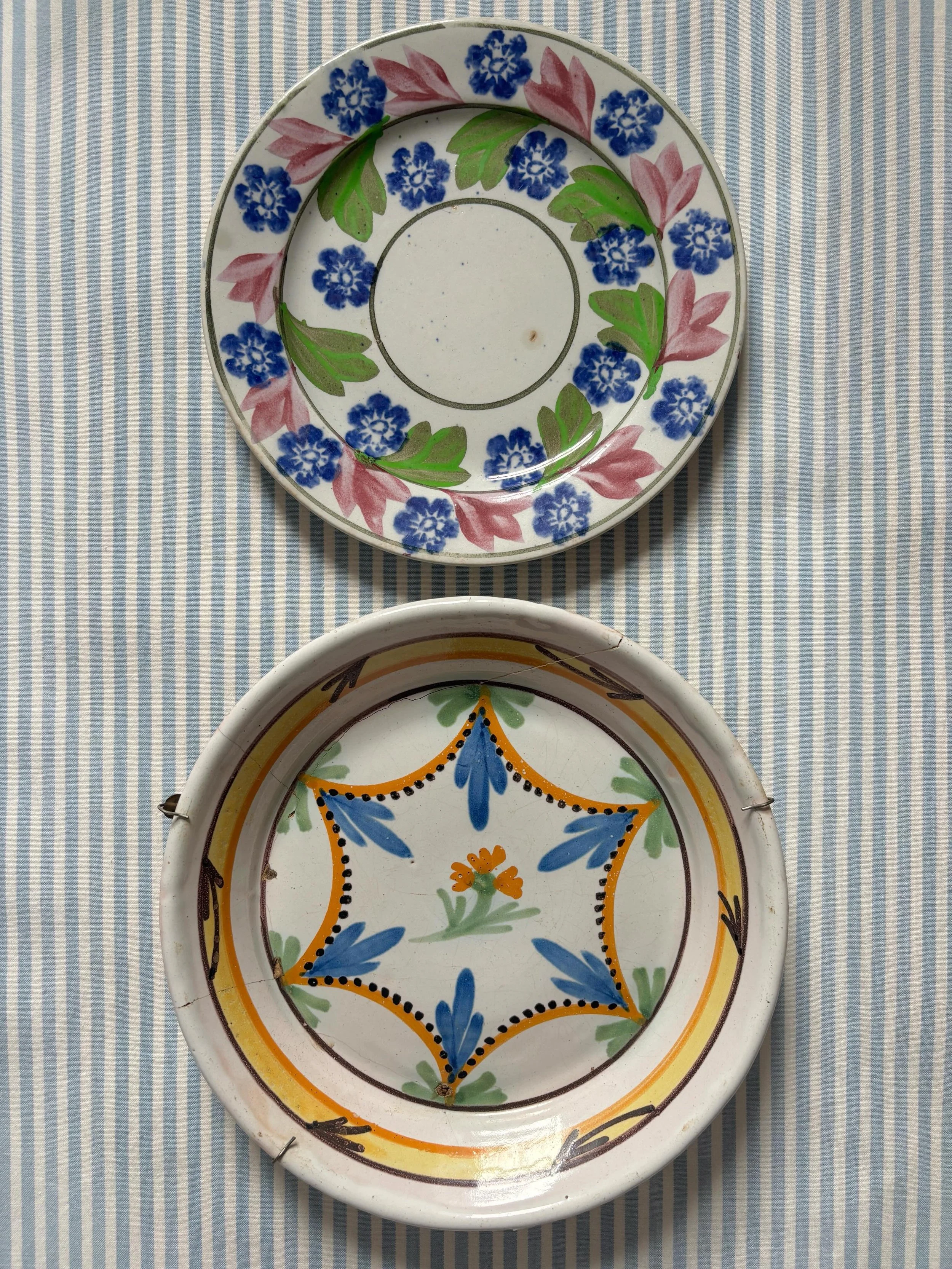 FOR SALE Two wonderfully decorative antique plates.

1.) A scarce 19th century French faience (tin-glazed earthenware) plate or shallow bowl. It has been na&iuml;vely decorated in a lovely rustic hand painted polychrome design and is a hugely charact
