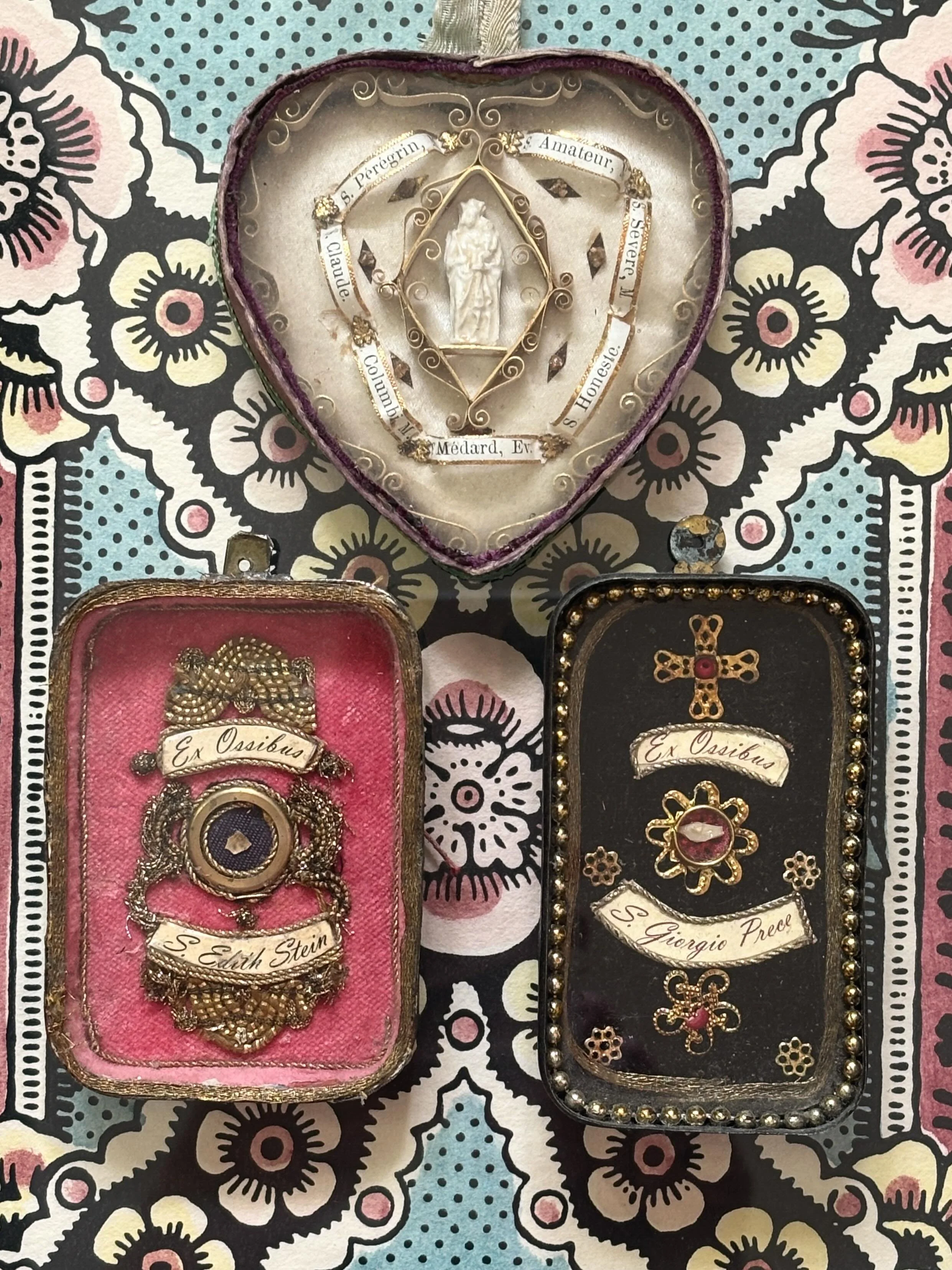 I recently added this beautiful little antique heart shaped reliquary to my fledgling collection of three! It is so meticulously detailed with minuscule gilt-edged scrolls around a central devotional figure. Surrounding this are the names of seven Sa