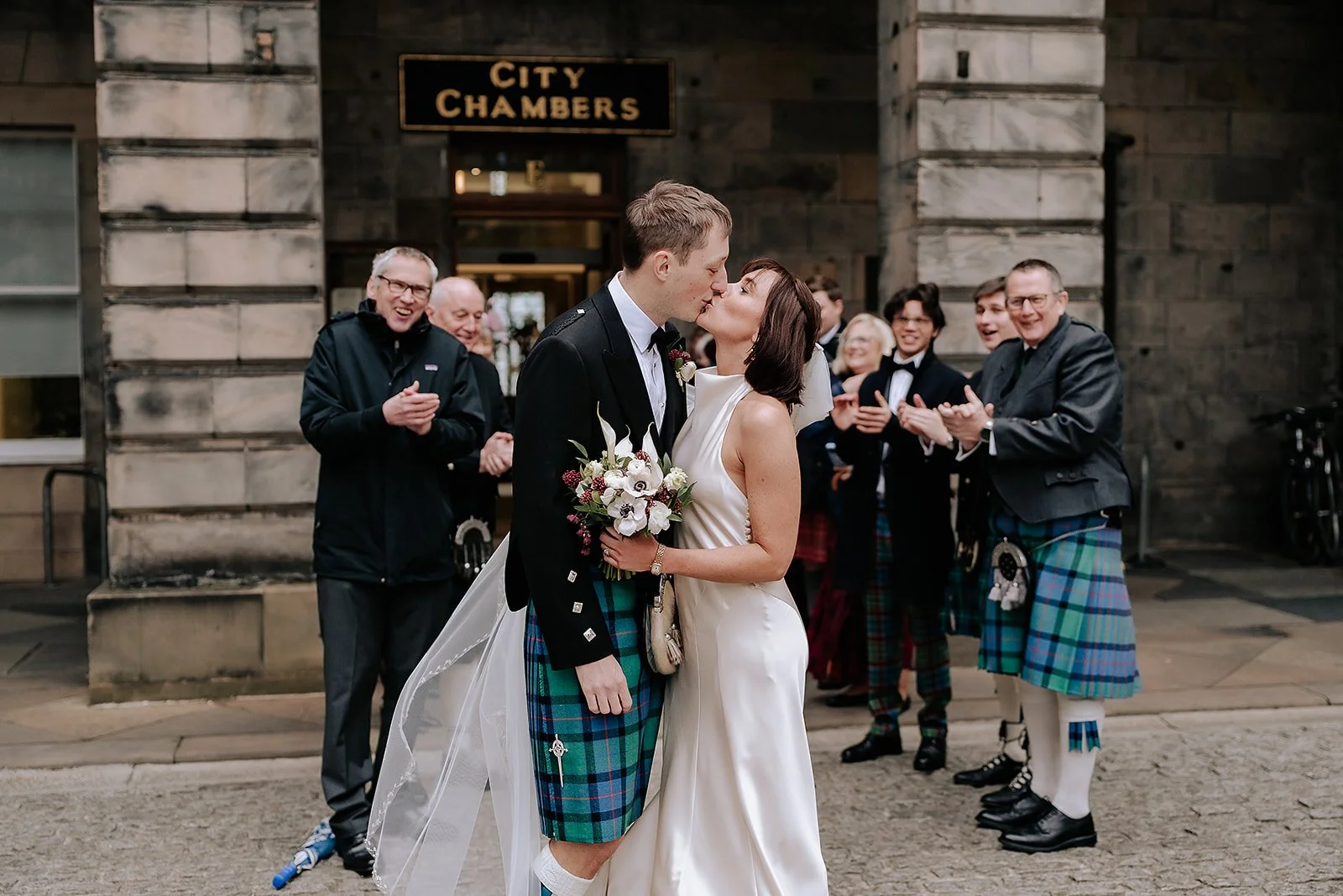 first kiss outside Edinburgh City Chambers wedding by Lou Rob Photo