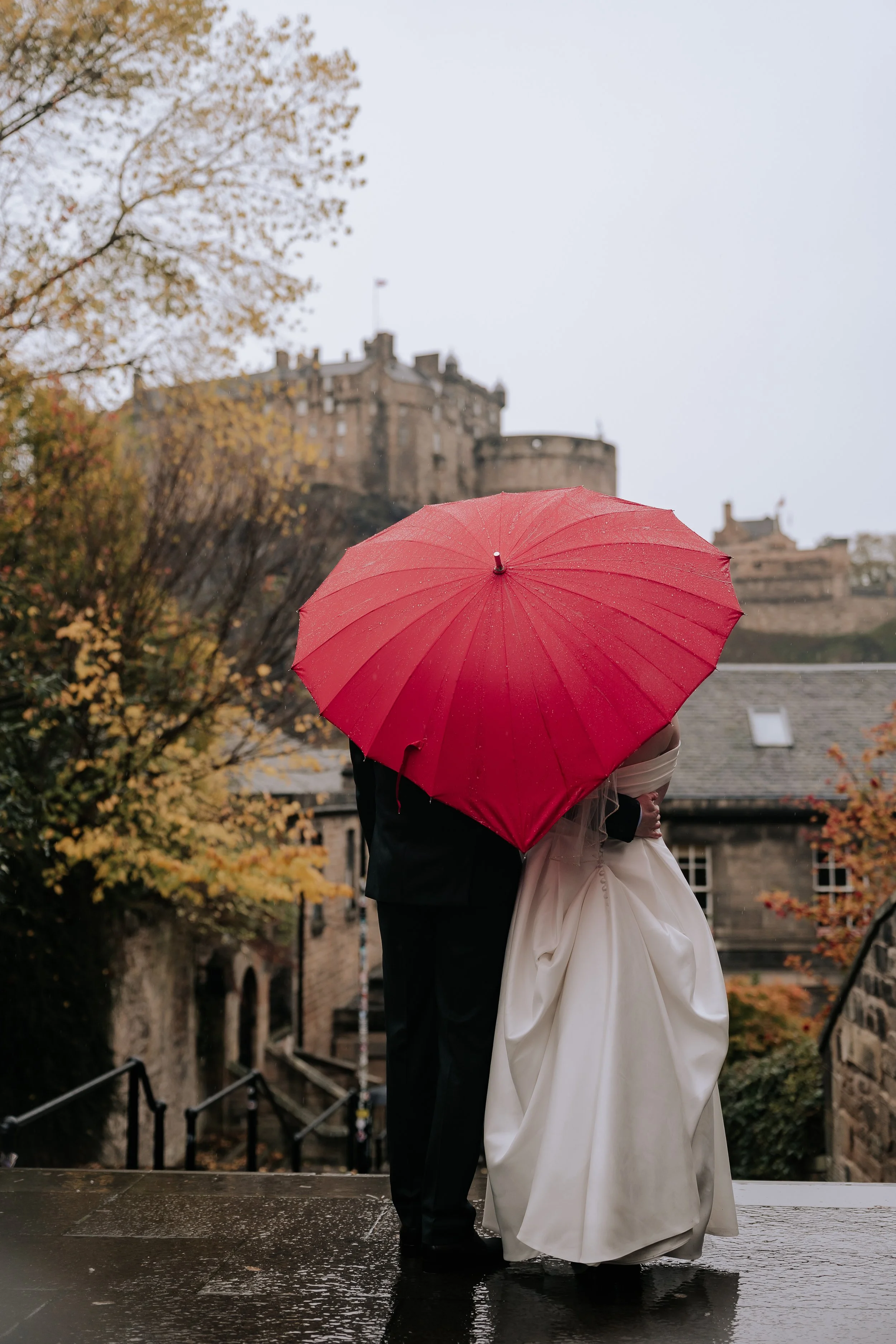 wedding couple at the vennel with umbrella - city wedding