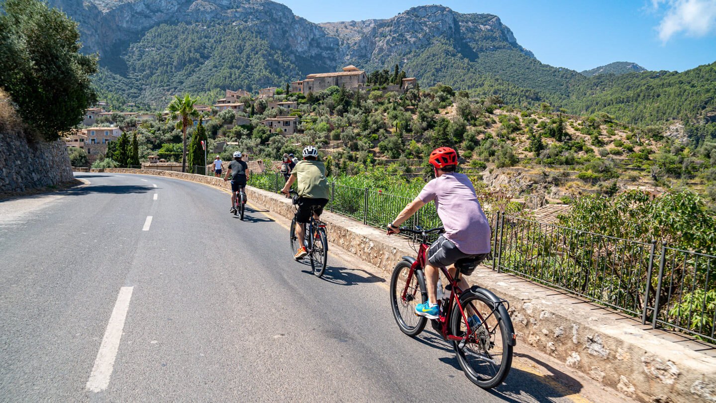 Guided cycling ride on electric city bikes with a visit of Tramuntana's Gem, Deia in Mallorca
