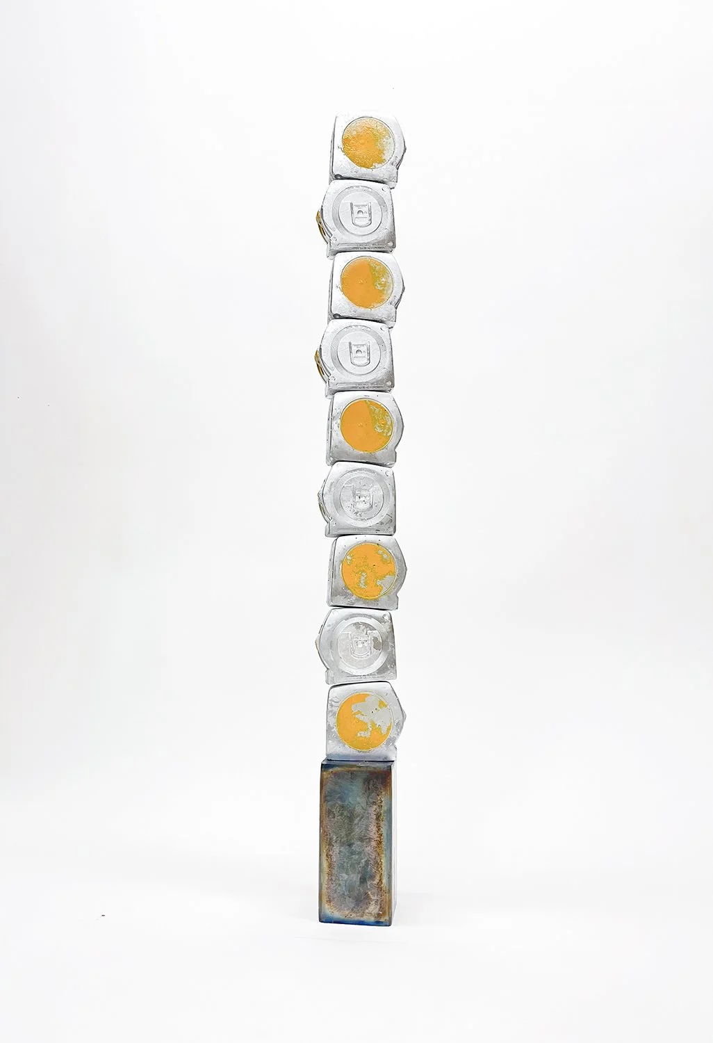 Aaron Cowan, "Measuring Up," cast plaster tape measures, heat-blued steel, paint, 2024