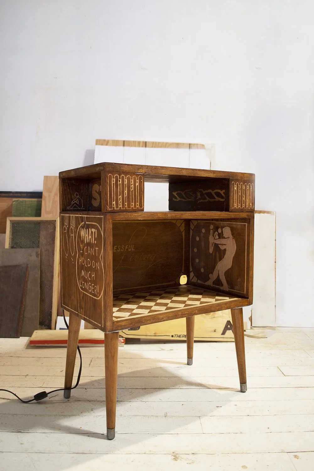 Evan Brien, "Down but not out," relief carving on found sidetable, 2023