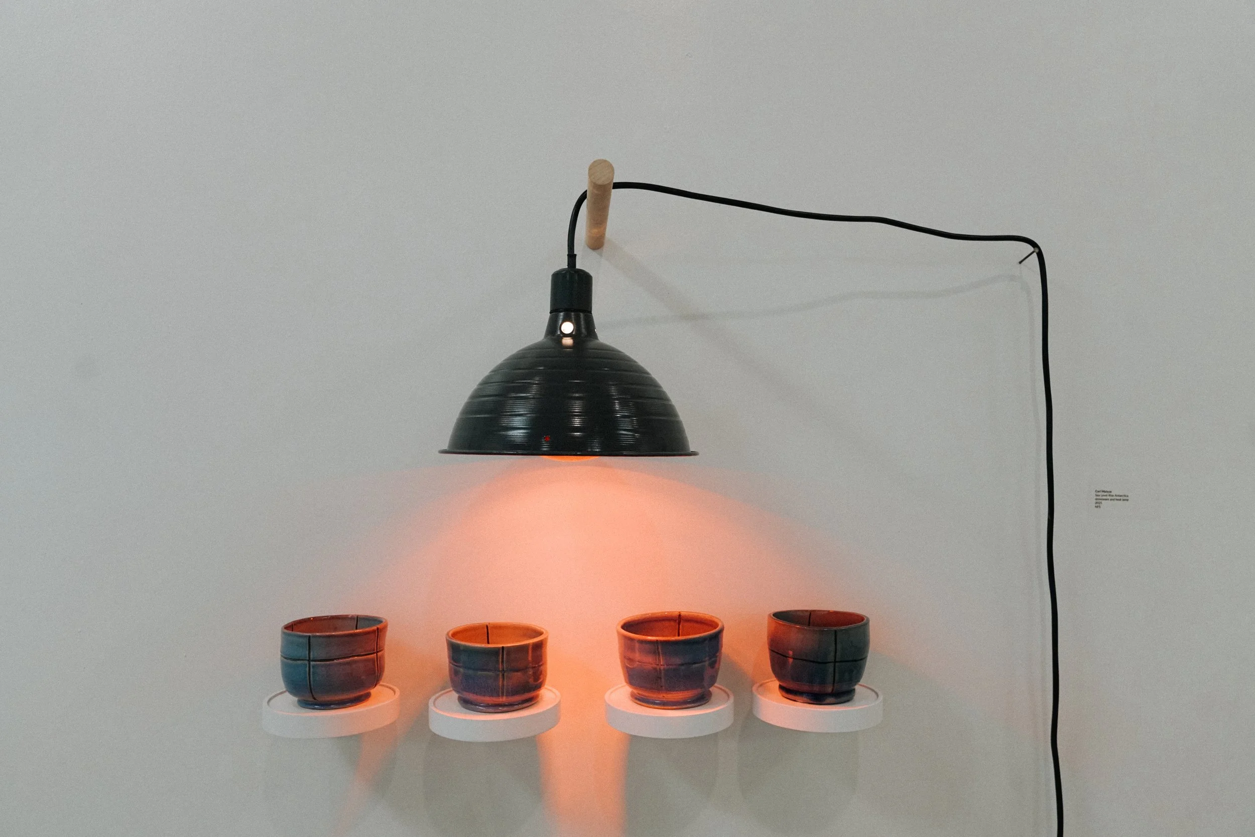 Cori Matyas, "Sea Level Rise Antarctica", stoneware and heat lamp, 2025