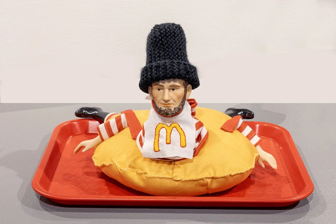 Erin Porrey, "McLincoln," thrifted ceramic doll parts, thrifted Ronald McDonald Halloween costume, stuffing, thread, yarn, embroidery, 2026