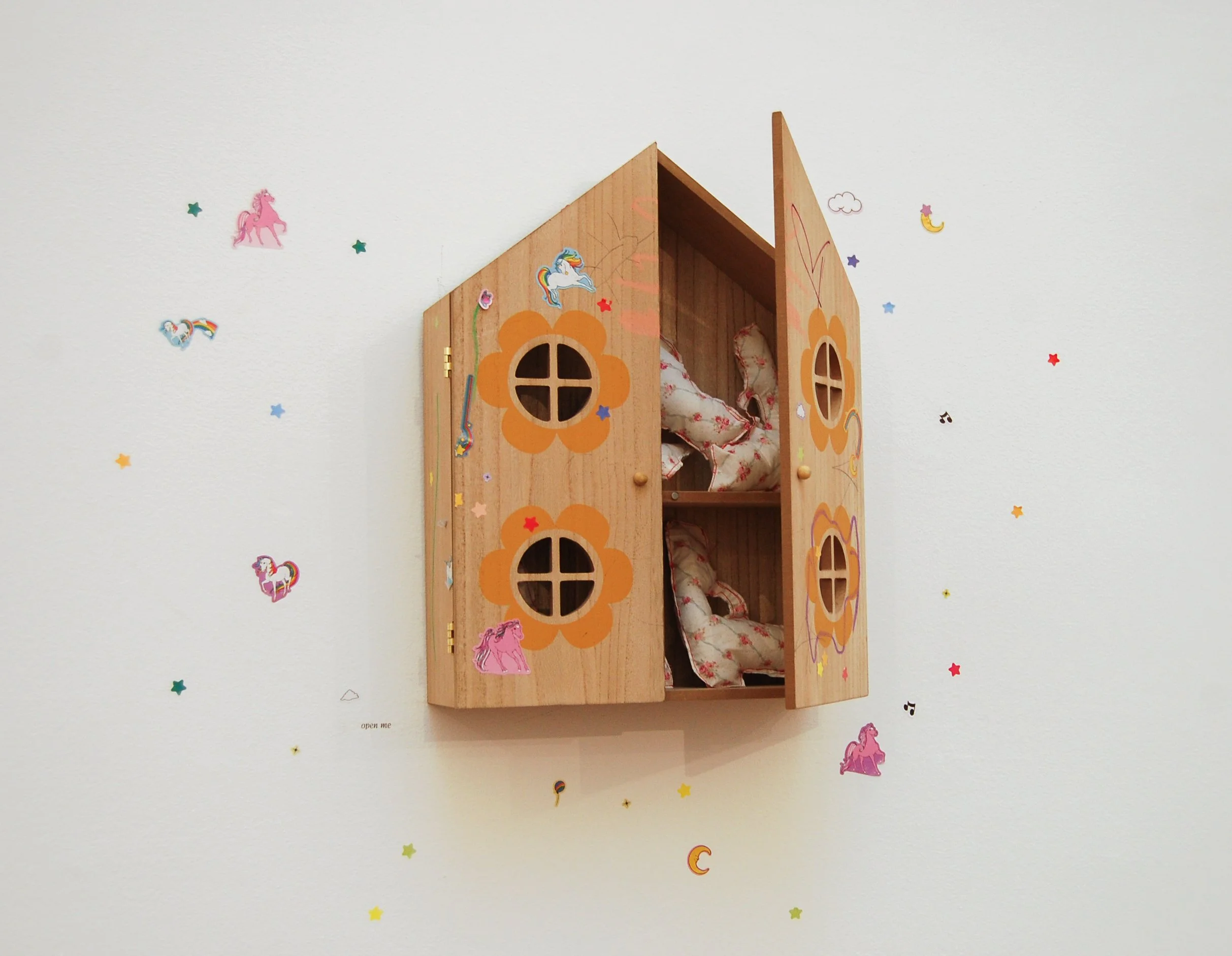 Electra Pelias, "gun cabinet," secondhand doll house, sewn pillow guns made from secondhand sheet, stickers, 2025