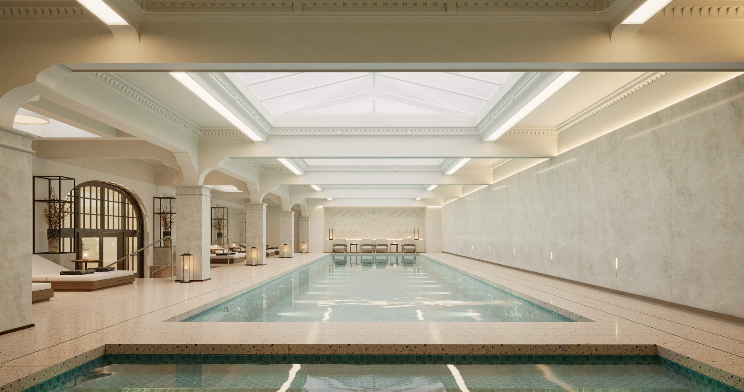Elegant indoor swimming pool area with natural light coming through a large skylight, surrounded by lounge chairs, plants, and decorative lanterns.