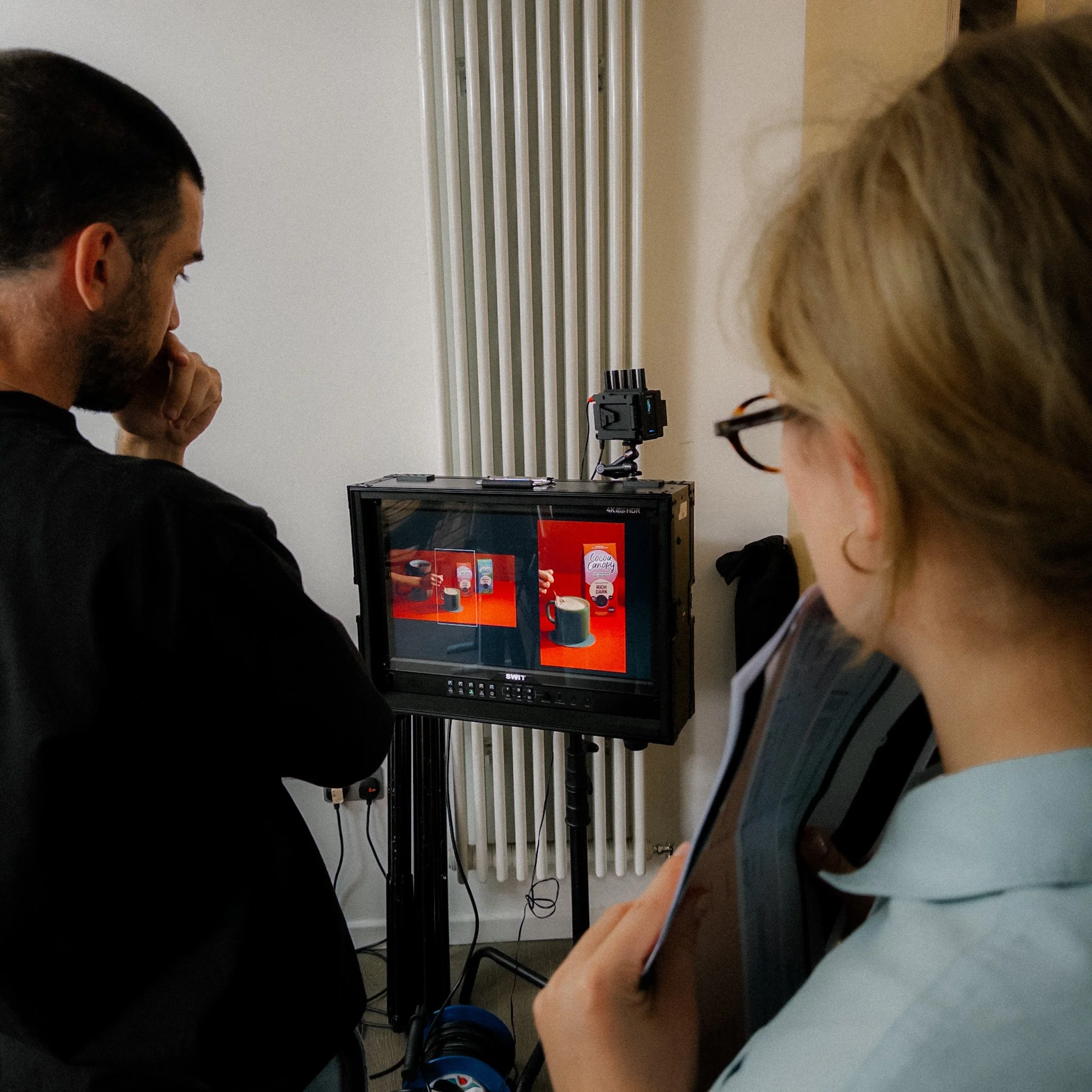 Clients reviewing footage on a monitor