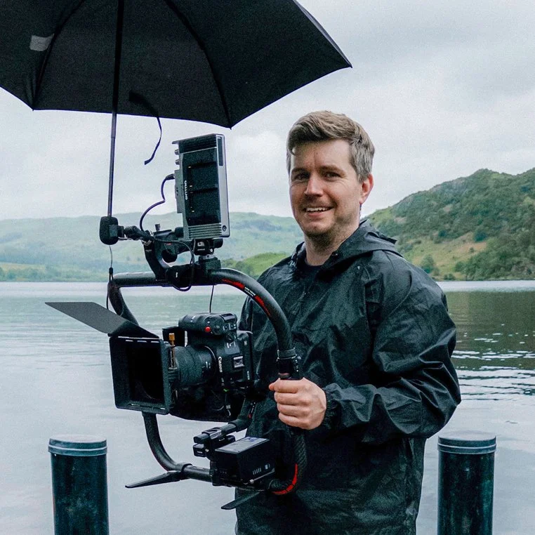 Rob Pinney, a London videographer, holding a camera on a shoot