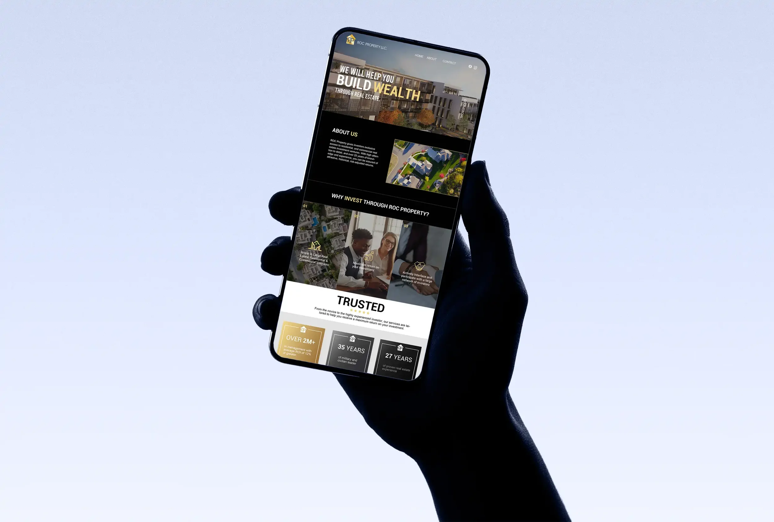 A person holding a smartphone in front of a clear sky, displaying a real estate investment website.