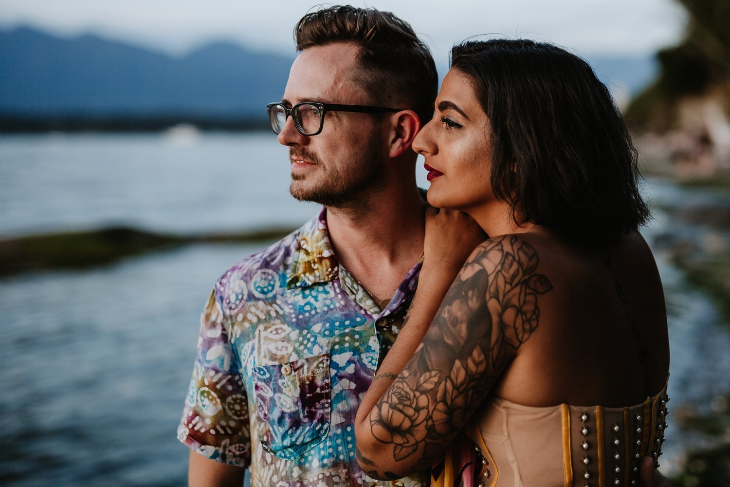 Engaged couple during their sunset beach photoshoot at Kitsilano Beach in Vancouver, BC.