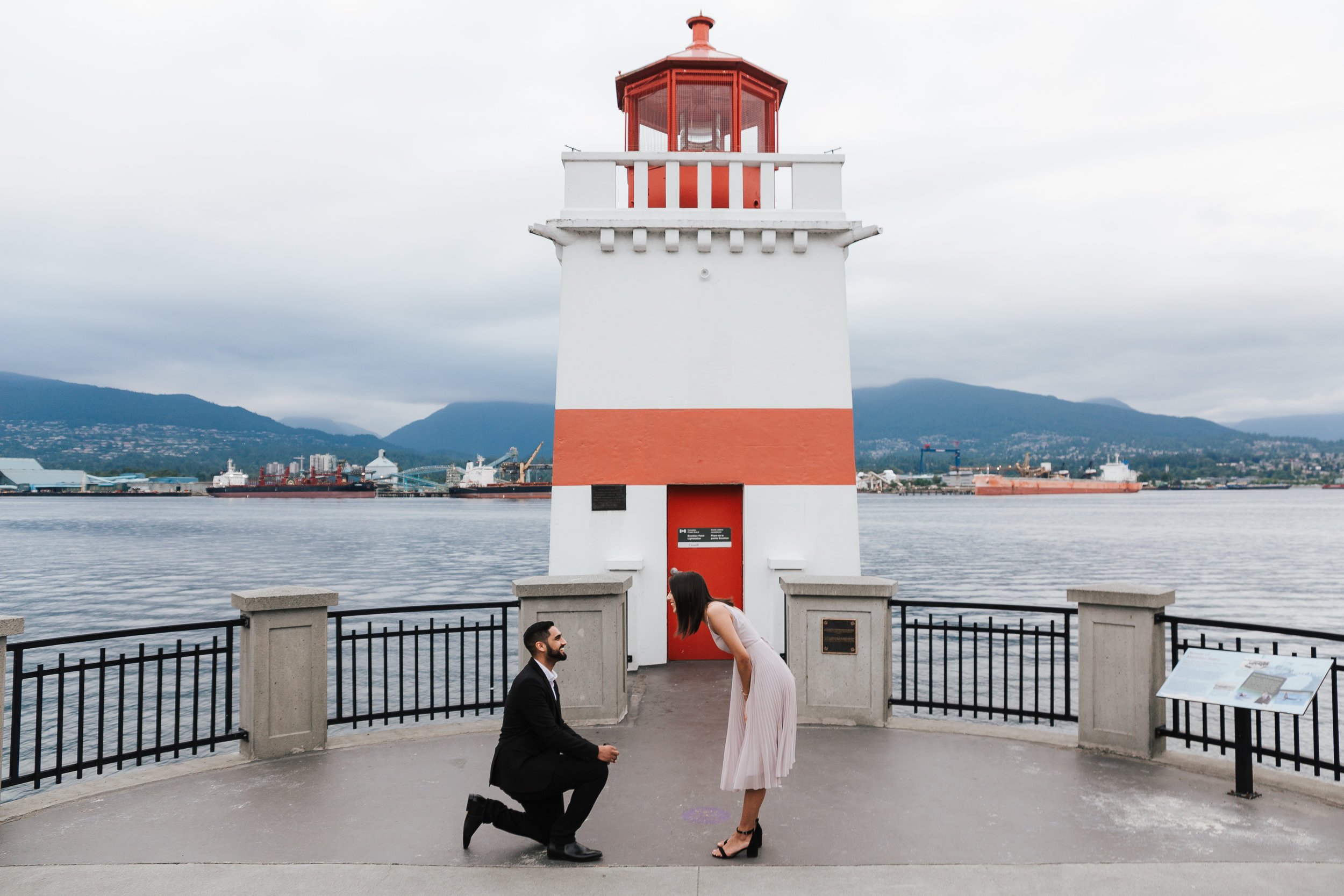 Boyfriend proposes to girlfriend at Brockton Point Lighthouse at Stanley Park.