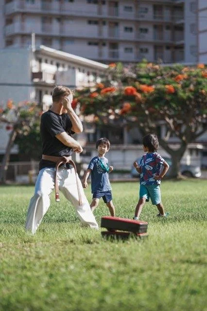 Aranami Dojo Instructor Ryan Layman demonstrates basic techniques in kid's class in Makiki District Park, Honolulu, Hawaii