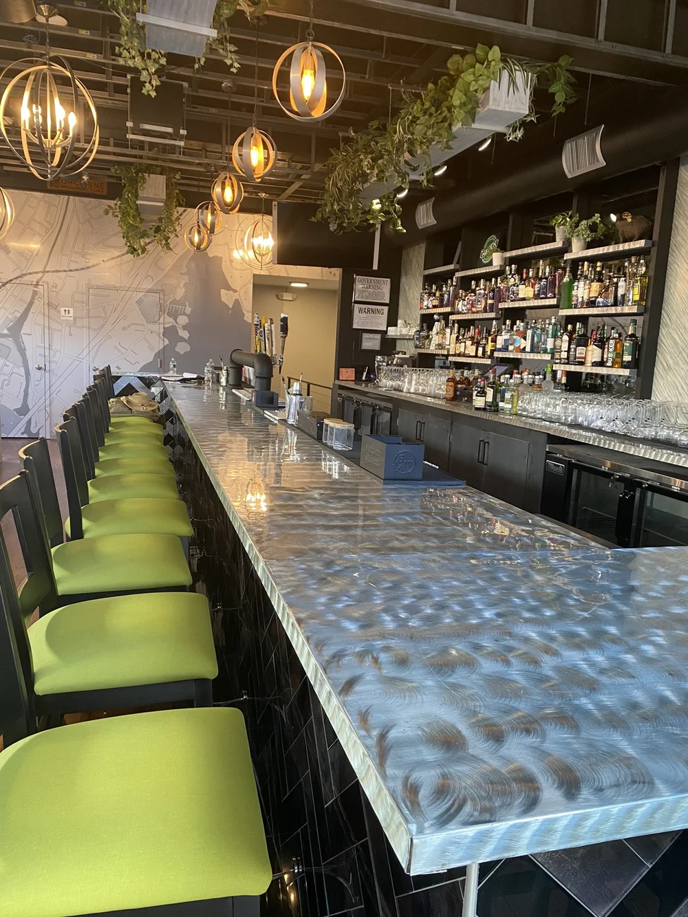 Haven's bar with lime green bar stools and pendant lights