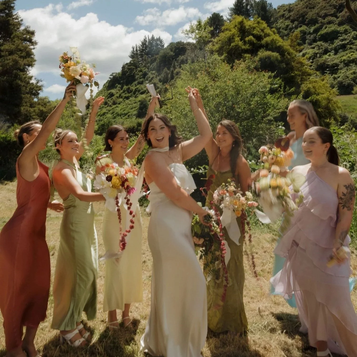 Bridal party. Bridesmaids, Bride holding flowers. Beautiful wedding dresses and flawless makeup. Natural glam, soft glam, beach wedding