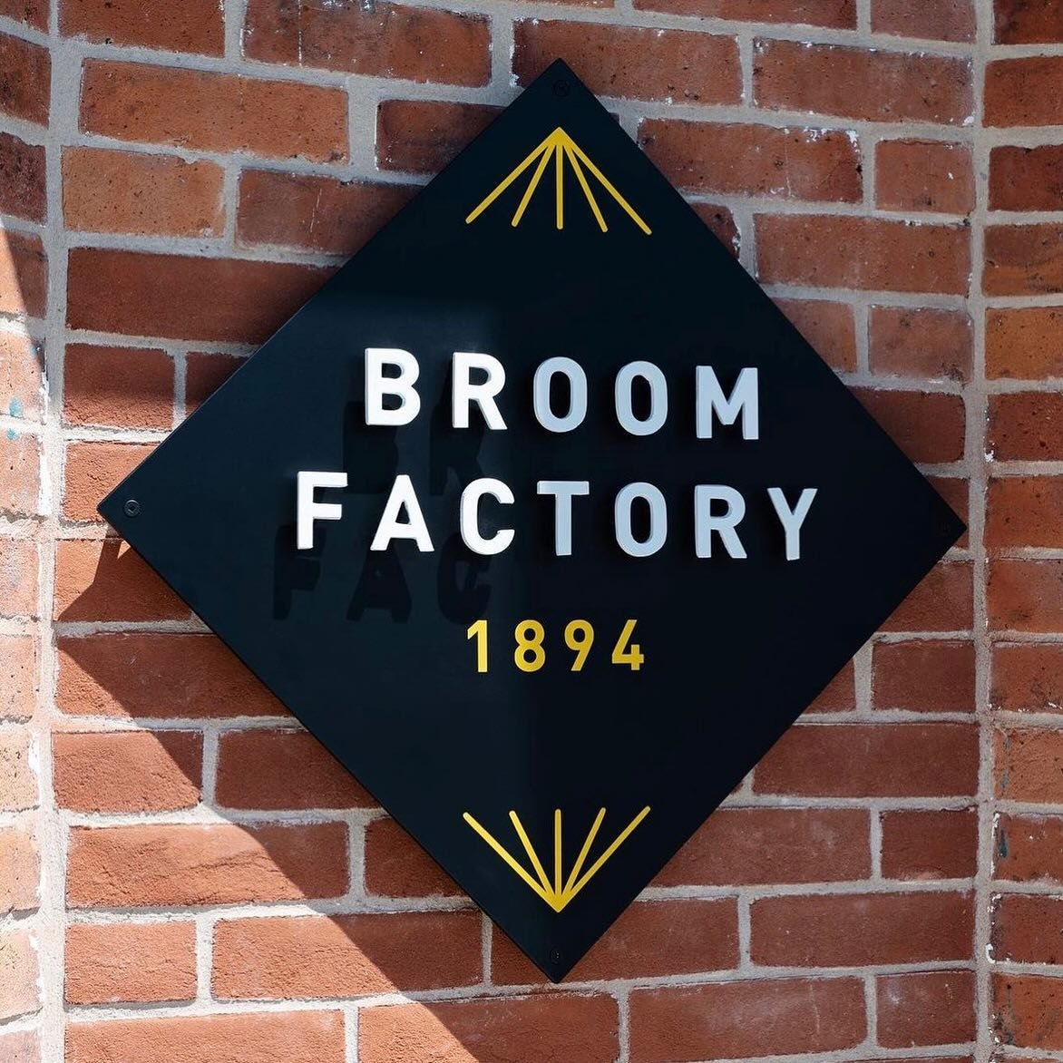 Signage design for The Broom Factory, a cultural centre established within a factory building dating back to 1894 in Kingston, Ontario. The space features a performance venue, a caf&eacute;, co-working facilities, and office spaces. Signage produced 