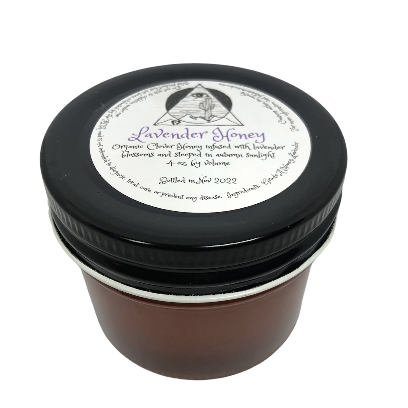 Photo of clear glass jar with black lid and Lavender Honey label featuring the Full Desert Weirdo logo.