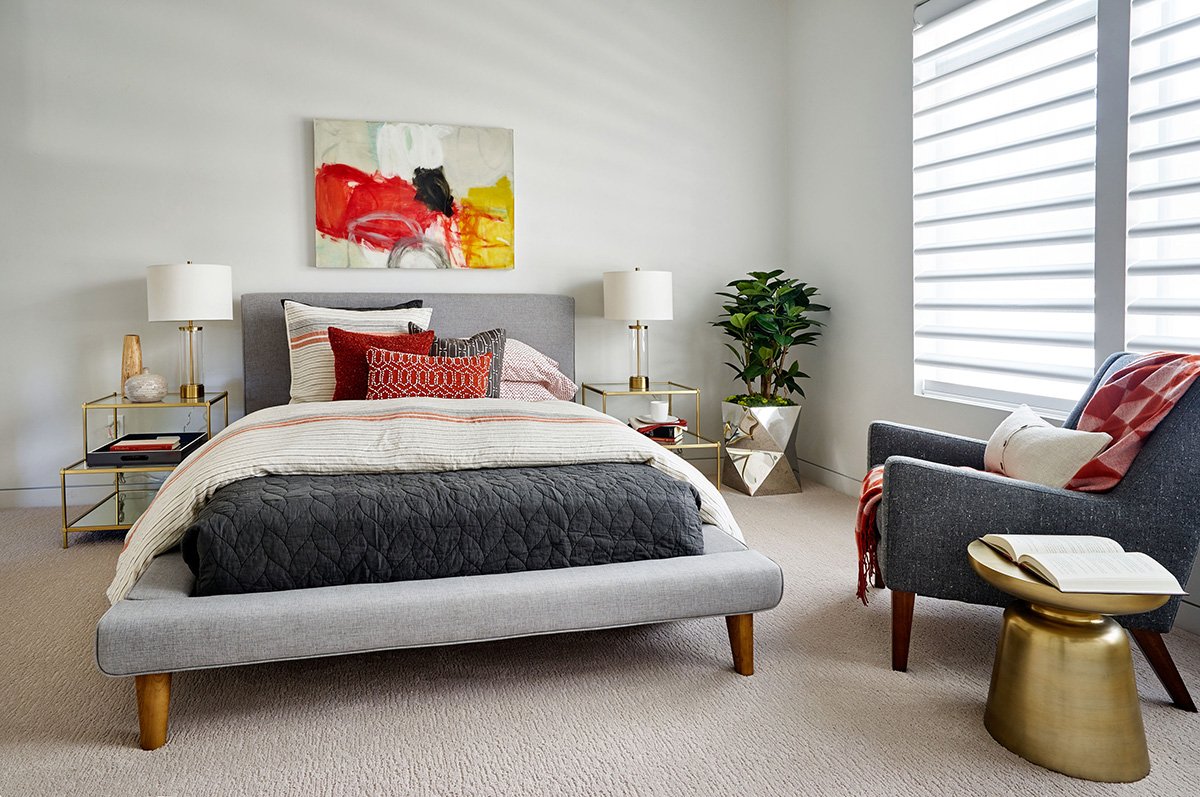 A bedroom featuring a bold painting.
