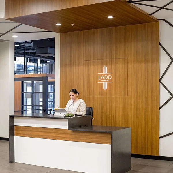 An apartment reception area with wood paneling.