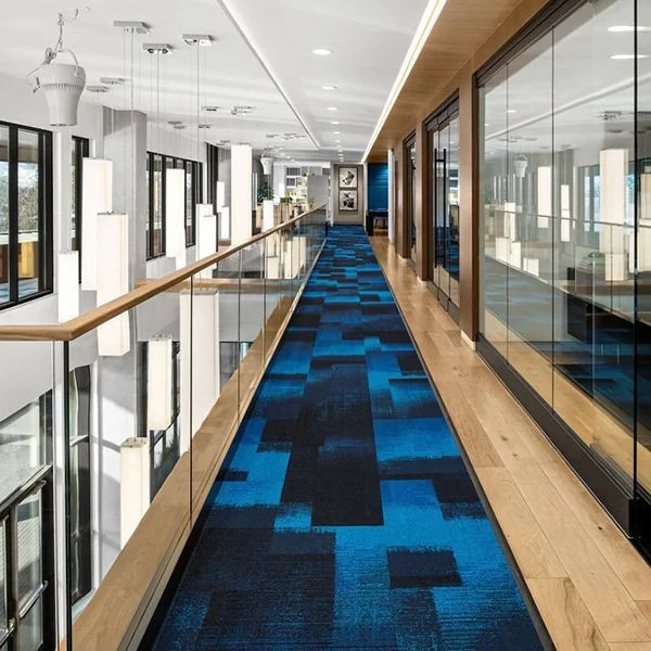 A walkway with blue patterned carpet.