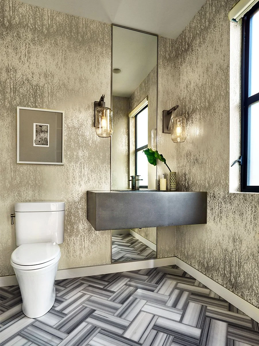 A curated powder bath with custom wallpaper and tile.