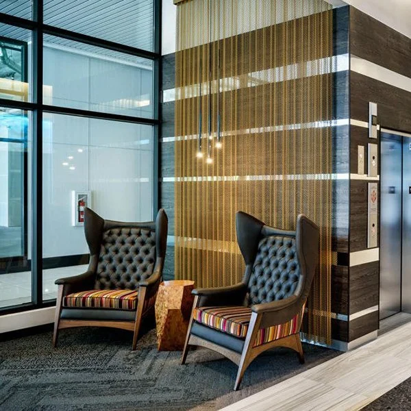 Two unique armchairs in a lobby.